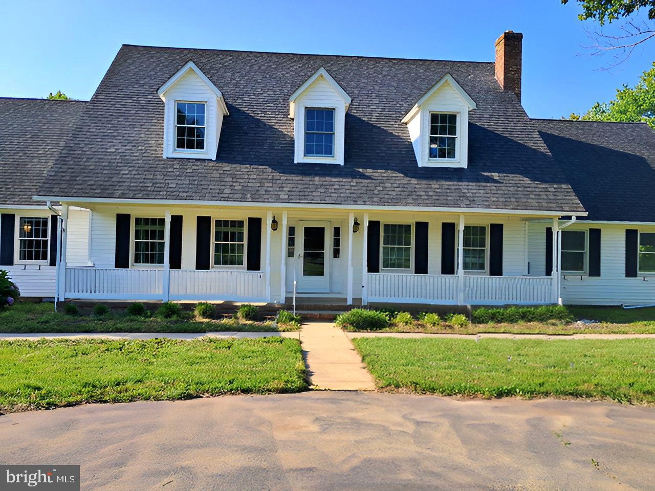 Experience the cham and comfort this porchfront home brings! This lovely custom-built home sits on an expansive 3-acre lot, featuring a white majestic picket fence and a grand circular driveway. The main level has an open-concept kitchen-dining combo with island table, granite countertops and appliances, that is adjacent to the living room with hardwood floors. The primary bedroom, which offers privacy and has serene pond views, is located on the first floor and has en-suite bathroom and walk-in closet, The primary bathroom consists of dual vanity, whirlpool tub and separate glass shower. Upstairs, you'll find four additional bedrooms with carpet flooring and built-in cabinets, two full bathrooms and an extra room complete with a kitchen counter and sink that opens to the balcony and has great view of the backyard. The rear outdoor space is wide and has a 28x40 outbuilding, originally designed as a kennel, and comes with separate metered electric and roughed-in plumbing. Location is a tranquil, private setting while being a convenient drive from the Weis Market, Patuxent River, Naval Air Station and surrounded by parks and waterfront activities, thus providing the residents with the perfect blend of seclusion and accessibility. So, don't miss this wonderful opportunity to make this home your own! Schedule a showing today. NOTE - To help visualize this home’s floor plan and to highlight its potential, virtual furnishings may have been added to photos found in this listing. Buyers winning the Highest & Best must understand that they participated in a Highest & Best, Multiple Offers Situation and that any requests to the Seller for Special Concessions, Repairs or Switch in Financing could result in the Seller terminating and retaining Buyer's EMD.