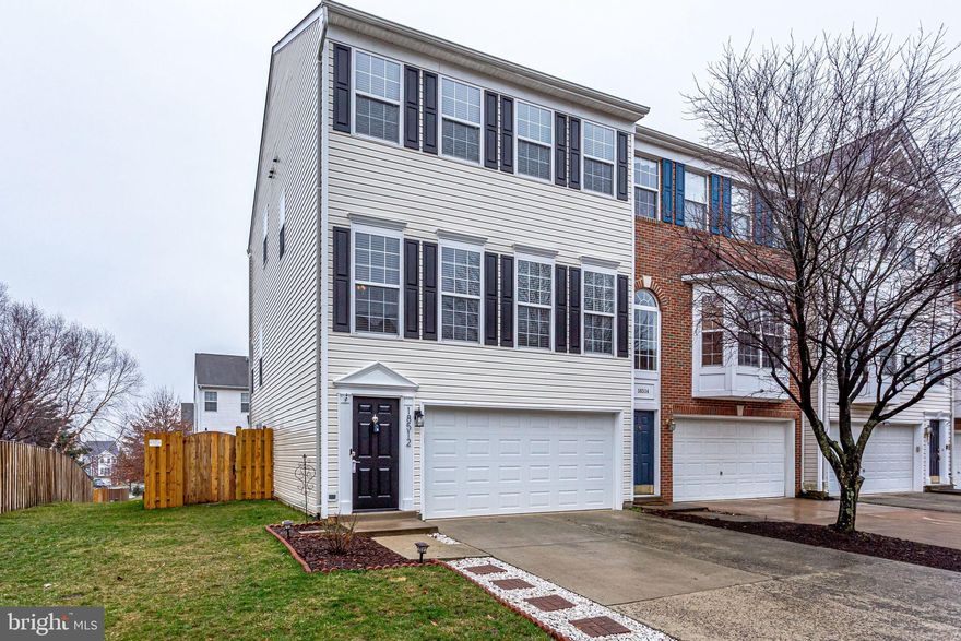 Beautiful End Unit Townhome with 2 car garage.  Warm wood floors welcome you on this open and useful main level.  Kitchen features 42 inch custom cabinets, granite countertops, SS appliances, stone backsplash, large sink and island.  Huge breakfast area and large pantry.  Sliding door out to newly resurfaced deck!  Living room with recessed lights and dining room features tray ceiling, crown molding and chair rail.  Upper level features 3 large bedrooms, 2 full baths and laundry room.  Master Bathroom features tile floor, sep tub, sep shower, dual sinks and new mirror and lighting.  Upper level hall bath with new mirror and lighting.  Lower level features large family room, full bath and walk out to rear fenced yard.