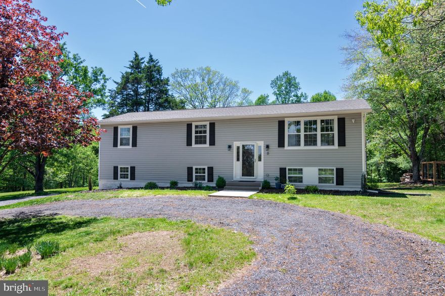 NEW PRICE, NEW LOOK!! NEW PICTURES!! This lovely home is a peaceful oasis from the busy commuting life BUT still close to restaurants, shopping and commuting.   Completely renovated split foyer home (2023) on scenic 5 acre lot (mostly flat) with circular driveway and ample parking.  Lovely open floorplan! Just about EVERYTHING is NEW! New roof and siding (2023). New windows (2023). New HVAC (2024). New hot water heater (2023). New well pump and well updated well (new pit-less adapter & well seal)  (2024). New well pressure tank (2024). New wood stove insert and new stainless steel lining from stove adapter to chimney (2024).  New flooring and lighting throughout! Open floorplan is great for entertaining!. Kitchen remodeled with new cabinets, new stainless steel appliances, new marble counters, new lighting and new flooring (2023). There is a large kitchen island with plenty of seating capacity. and there is table space to boot! The adjoining formal living room is light filled and perfect for entertaining!  Three good sized bedrooms and two full bathrooms complete this level. Bathrooms have been completely renovated  with new walk-in shower w/ custom tile (primary bath), new tub/shower combo in hall bath, new vanities, lighting, toilets and flooring in all bathrooms!  The lower level has a great sized family room with a wood burning fireplace (new insert in 2024), lots of light and a SGD to the yard. There are two bonus rooms, one with a  closet, a full renovated bathroom, and a separate laundry room. Septic inspected and pumped 7/2023. The property features an 8' deer proof garden just waiting to provide you with a future harvest. There is a large shed that has been converted into a chicken coop with a run. Considering the still high price of eggs, buy yourself some chickens and gather your own fresh eggs! There are also two young apple tree along with a producing pear tree.  Can you say pie? You have the potential to be self-sustaining!  Sit on the deck and enjoy your coffee or tea and the  daily sunrises which are spectacular!   DO NOT MISS the opportunity to make this lovely home your little slice of heaven! What are you waiting for?