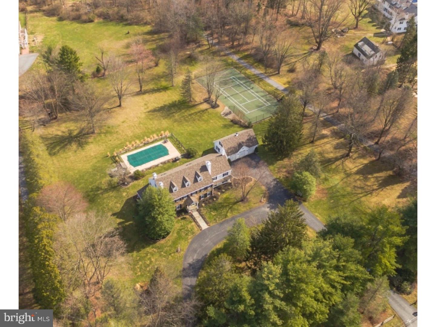 An awesome three story, stone country home with a Paoli mailing address in the heart of Willistown Township. A perfect location for the commuter to access the Paoli train station and Route 30 shops and restaurants! Exterior accents include circular tree lined driveway, mature landscaping, brick lined covered porch overlooking updated in-ground pool, tennis court and 3.1 acre lot. Inside, the entry hall extends from front-to-back and is complemented by antique brick flooring and wainscoting. Formal living and dining rooms are both highlighted by brick wood-burning fireplaces. Family Room, complete with wet bar area, built-ins, picture window, exposed beams and brick fireplace. Kitchen features center island and comfortable eating area. Family entry on side to access pantries, walk-in coat closet, laundry room, second half bath and private home office. Front and back staircases lead to the second floor. Just a few steps away from the bedroom hallway is a large second family room with high ceilings and large brick fireplace with raised hearth and exposed beams. Additionally, the second floor features a master suite with updated full bath, three generously sized bedrooms, one with a private en suite bath, the remaining two bedrooms are serviced by updated hall bath. Private third floor offers sitting room, full bath and oversized fifth bedroom. Newer skylights and dormer windows create a light, bright third floor, perfect for out-of-town guests or au pair.