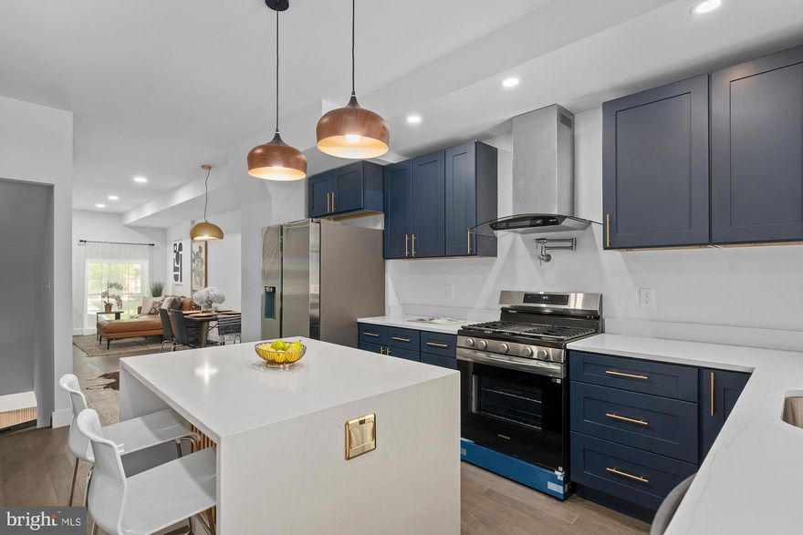 Welcome to 3713 E Fayette—rebuilt from top to bottom, this stunning townhome blends modern design with effortless city living in the heart of East Baltimore.

Step inside to a sleek, open main level featuring matte-finish floors, custom metal railings, and oversized windows that flood the space with natural light. The layout flows seamlessly from the living area into a dedicated dining space and a striking midnight blue kitchen, complete with a waterfall island, stainless steel appliances, sleek quartz countertops, a pot filler over the stove, and a powerful 900 CFM exhaust vented to the exterior—ideal for both everyday cooking and serious culinary use. Just beyond, step out to the private patio—perfect for grilling and outdoor relaxation.

The second level offers a beautifully designed en-suite retreat, showcasing soft leaf green tile, a custom vanity, soaking tub, trendy lighting, and a towel warmer for a spa-like, designer feel. Two additional bedrooms provide flexibility for guests, office space, or family, along with a stylish full bath finished in French canvas glazed ceramic tile and a walk-in shower with river stone flooring. The rear bedroom opens to a private balcony—your own quiet escape.

The fully finished lower level is built for entertaining, featuring oversized Calacatta tile, a sleek electric fireplace that adds warmth and ambiance, and a convenient half bath.

This home has been thoughtfully rebuilt with major upgrades including new HVAC, electrical, plumbing, roofing, and framing—offering peace of mind and modern efficiency for years to come.

Located in a growing East Baltimore neighborhood, this home offers easy access to Johns Hopkins Hospital, Patterson Park, and major commuter routes, while being just minutes from downtown Baltimore’s dining, shopping, and waterfront attractions.