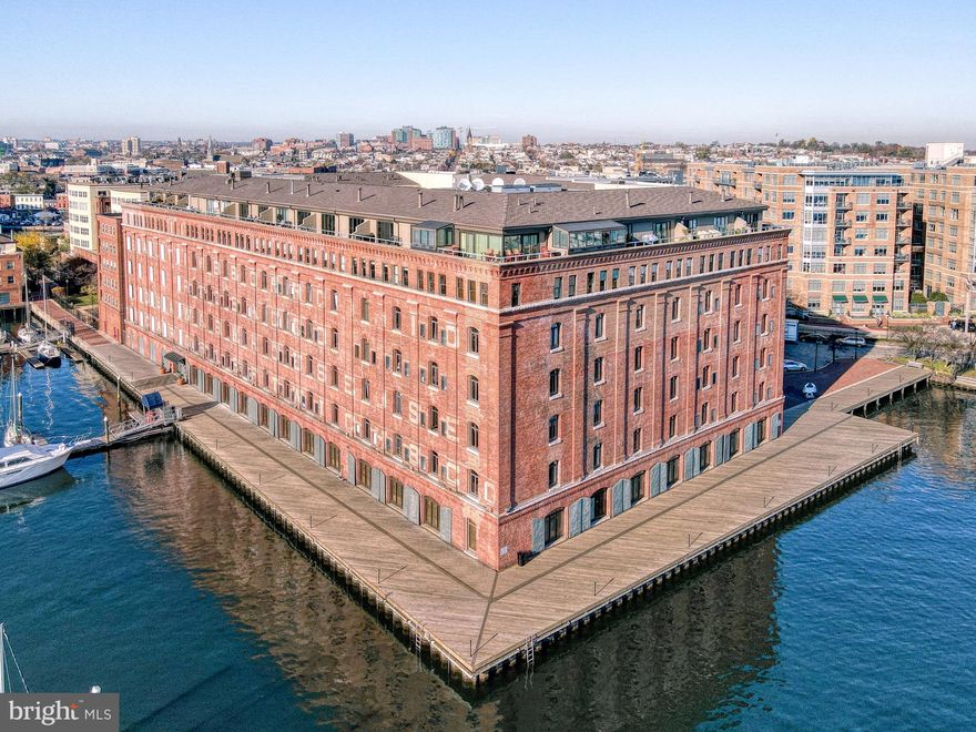 Experience elevated waterfront living with stunning water views in this exceptional 2,768-square-foot, two-level penthouse residence—one of the largest floor plans at Henderson’s Wharf in the heart of historic Fells Point. Perched above the harbor at 1000 Fell Street #612, this light-filled home offers an unparalleled waterfront lifestyle with sweeping vistas of the marina, city skyline, and ever-changing harbor.
Expansive windows frame breathtaking views and fill the home with natural light, while the elevated penthouse position provides both privacy and a front-row seat to Baltimore’s vibrant waterfront. From morning coffee as boats glide by to evenings with city lights reflecting across the water, every moment here is defined by the view.

The main level welcomes you with raised ceilings, rich hardwood floors, and an open-concept design ideal for both everyday living and entertaining. The beautifully updated kitchen features granite countertops, stainless steel appliances, and a generous layout that flows seamlessly into the expansive living and dining areas—perfectly oriented to capture captivating water views. A stylish half bath adds convenience for guests.

Upstairs, the private quarters offer a true retreat. The primary suite is a sanctuary, complete with a sitting room featuring a wood-burning fireplace—perfect for cozy evenings. The suite is complemented by a well-appointed bath and private balconies overlooking the water, creating a peaceful, resort-like setting. A second bedroom offers its own charm with a garden-view balcony, ideal for guests or a serene home office.

Located along the coveted waterfront promenade, this residence places you just steps from Fells Point’s cobblestone streets, boutique shops, acclaimed dining, and lively cafés. Enjoy easy access to the Baltimore Harborwalk, perfect for scenic strolls along the water.

With its rare penthouse vantage point, expansive layout, and breathtaking views, this is a truly exceptional opportunity to experience waterfront living at its finest.