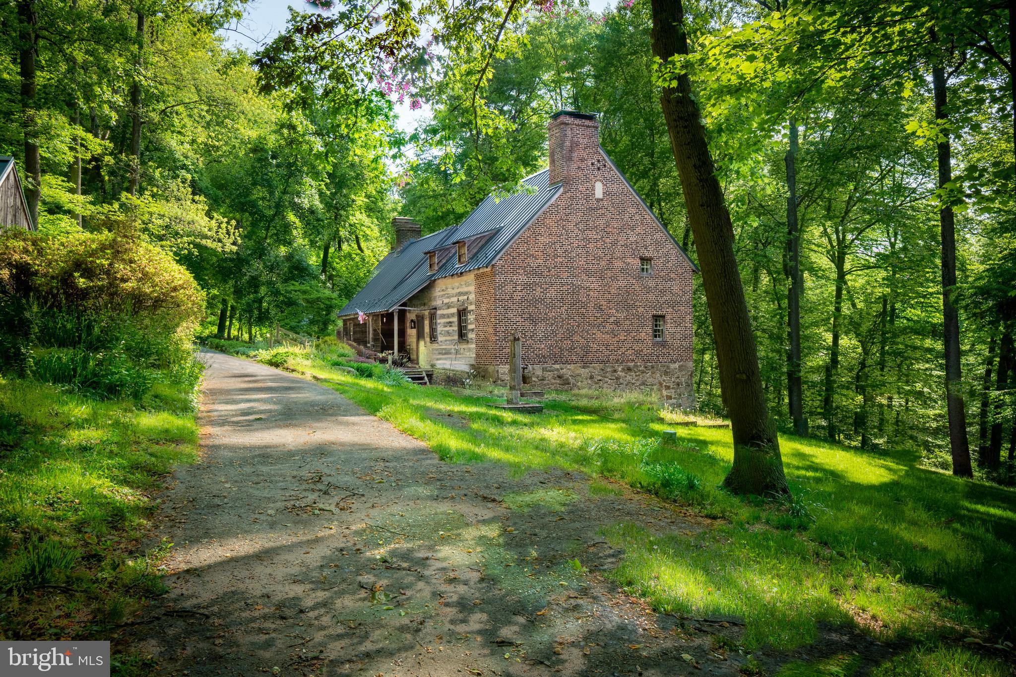 Located in one of Chester County's most desirable valleys and positioned beside the South Branch of the French Creek, this charming and secluded home is situated on over 20 acres. Iron Bridge Farm is a beautifully restored historic log home, nestled in a picturesque spot at the end of a long private lane.Exposed wooden beams, hemlock floors, a walk-in fireplace, and an abundance of natural southern exposed light can be found through-out the first floor. The kitchen has generous cabinet space and a large window overlooking the creek. There is a porch off the kitchen with a spacious deck perfect for al fresco dining and entertaining, offering spectacular views of the meadow, stream and creek. The first floor master bedroom has a sitting area and separate dressing room. The second floor has two bedrooms, each with a dressing room, and a connecting bathroom. The property features a pool with cabana and patio.Across from the main house is a two story barn with a first floor studio and a generous second floor. Continue down the lane, crossing the idyllic stream, and find a 4-car carriage building. A fully functioning barn perfect for goats, sheep, llamas or alpacas, contains a milking room, 6 stalls and a cheese kitchen. Iron Bridge Farm produced some of the finest, national award winning Chester County goat cheese.Iron Bridge Farm offers a quaint tenant home, perfect for a caretaker, second residence, or rental. It features 1 bedroom, 1 bathroom, a walk-in closet, an open living room with apothecary window, and a cozy kitchen. The covered porch faces the French Creek. Iron Bridge Farm has been impeccably maintained and appeals to the discerning country buyer. Welcome Home!