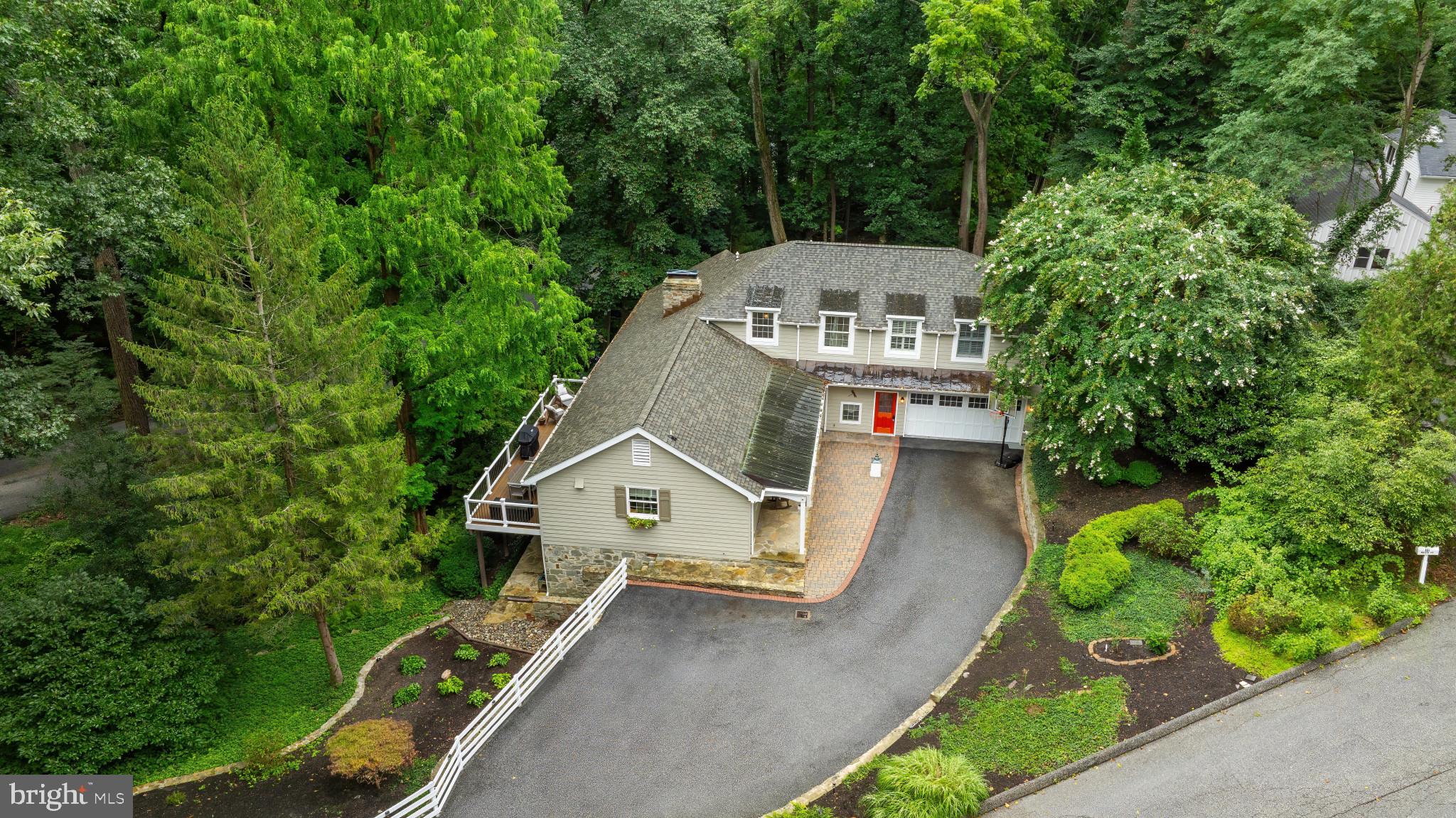 Welcome to 901 Navy Rd, a tranquil retreat in the heart of Ruxton. Set amidst mature trees and lush landscaping, this 4-bedroom, 3½-bath home offers privacy while offering so many conveniences such as local shopping, restaurants, hospitals and much more along with easy access to major roadways. Beautifully updated throughout with fine craftsmanship, this home showcases a thoughtful blend of traditional elegance and modern sophistication while offering a versatile floor plans. The interior boasts sun-drenched living spaces, beautiful architectural details and designer finishes.
The open-concept main level is ideal for both relaxed living and entertaining. As you enter the home, a warm foyer greets you with custom storage closets and convenient powder room. A gorgeous designer kitchen showcases a large, walk-in pantry, custom cabinetry and countertops, spacious island, high end appliances including a Jenn Air 6-burner gas range, GE Café refrigerator and dishwasher. The kitchen overlooks a beautifully designed space encompassing a dining area, adjacent living room and access to a new, 400 sq ft composite deck from both rooms. A dramatic floor to ceiling stone fireplace is a focal point in the living room and offers privacy for a comfortable family room tucked back off the main level. The main level also offers a versatile en suite bedroom or study and seamless access to outdoor living on the new patio and hardscaped yard.
The upper-level primary suite is a private retreat with vaulted ceilings with accent beam, custom built-ins, multiple closets including a spacious walk-in closet. Relax in the beautiful spa like bath with separate shower and tub, dual vanities and radiant heated floors.
The bright, fully renovated lower level doubles the living area with a spacious recreation room surrounding another floor to ceiling stone fireplace and including a wet bar, two additional bedrooms, full bath, and walkout access to the patio and terraced entertaining spaces. A finished laundry room (2022 ) and storage area complete the lower level.
Extensive upgrades include: full basement renovation with wet bar (2021), new composite decks and stone patio (2022), new water heater (2022), roof and gutters (2023), well pump, storage tank, plumbing (2024). Comprehensive list of updates available for this this beautiful, turnkey property in the most desired neighborhood in Baltimore!