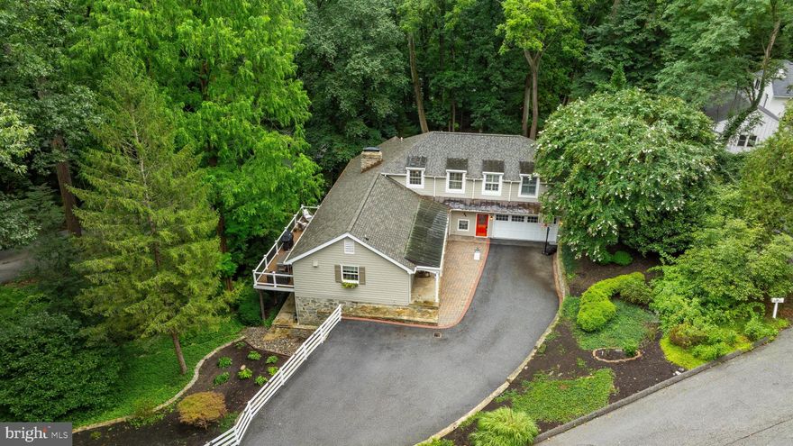 Price Refinement... Great value! So  Welcome to 901 Navy Rd, a tranquil retreat in the heart of Ruxton. Set amidst mature trees and lush landscaping, this 4-bedroom, 3½-bath home offers privacy  while offering so many conveniences such as local shopping, restaurants, hospitals and much more along with easy access to major roadways.  Beautifully updated throughout with fine craftsmanship, this  home showcases a thoughtful blend of traditional elegance and modern sophistication while offering a versatile floor plans.  The interior boasts sun-drenched living spaces,  beautiful architectural details and designer finishes.   
The  open-concept main level is ideal for both relaxed living and entertaining.  As you enter the home, a warm foyer greets you with custom storage closets  and convenient powder room. A gorgeous designer kitchen showcases a large, walk-in pantry, custom cabinetry and countertops, spacious island, high end  appliances including a Jenn Air 6-burner gas range, GE Café refrigerator and dishwasher.  The kitchen overlooks a beautifully designed  space encompassing a dining area, adjacent living room and access to a new, 400 sq ft composite deck from both rooms.  A dramatic floor to ceiling stone fireplace is a focal point in the living room and offers privacy for a  comfortable family room tucked back off the main level.    The main level also offers a versatile en suite bedroom or study and  seamless access to outdoor living on the new patio and hardscaped yard.
The upper-level primary suite is a private retreat with vaulted ceilings with accent beam, custom built-ins, multiple closets including a spacious walk-in closet.  Relax in the beautiful spa like bath with separate shower and tub, dual vanities and radiant heated floors. 
The bright, fully renovated lower level doubles the living area with a spacious recreation room surrounding another floor to ceiling stone fireplace and including a wet bar, two additional bedrooms, full bath, and walkout access to the patio and terraced entertaining spaces. A  finished laundry room (2022 ) and storage area complete the lower level. 
 Extensive upgrades include: full basement renovation with wet bar (2021), new composite decks and stone patio (2022), new water heater (2022), roof and gutters (2023), well pump, storage tank, plumbing (2024).  Comprehensive list of updates available for this this beautiful, turnkey property in the most desired neighborhood in Baltimore!