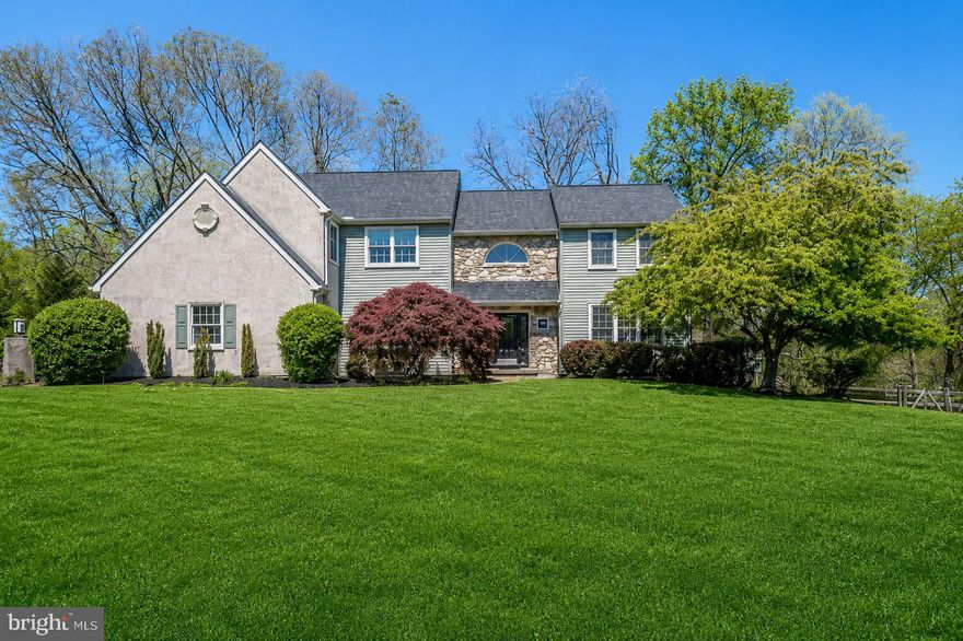 Welcome to 10 Trotter Way, an exceptional executive residence set on a breathtaking 1-acre homesite in the highly sought-after Prancing Horse Farms community of Upper Providence Township. Surrounded by mature trees and serene natural beauty, this distinguished center-hall colonial offers just about 3900 square feet of finished living space, including a thoughtfully finished walkout lower level of approximately 900 square feet. The home delivers an ideal blend of privacy, scale, and timeless design, with a stately presence that immediately impresses and a bright, open interior layout designed for both elegant entertaining and comfortable everyday living.
The main level welcomes you with a sun-filled foyer and opens into a refined yet inviting living room, complete with French glass doors leading to a screened-in porch overlooking the picturesque grounds. A formal dining room with chair rail and crown molding provides the perfect setting for gatherings, while a discreetly placed powder room adds convenience. The dramatic vaulted family room is anchored by a striking stone fireplace, creating a warm and impressive focal point, and a private library with its own fireplace offers flexibility as a second office or quiet retreat. At the heart of the home, the expansive gourmet kitchen is both functional and inviting, featuring abundant cabinetry, generous workspace, a sunlit breakfast area with tranquil views of the wooded rear yard, and a 2nd office just off the kitchen. An additional set of French glass doors leads to a spacious deck that extends the living space outdoors, while a beautifully designed paver patio below enhances the home’s exceptional outdoor lifestyle. Hardwood flooring throughout the foyer, kitchen, and breakfast area adds warmth and continuity. Additionally, there is another set of glass French doors that connect to the deck. Seamlessly bringing the outdoors in, making entertainment effortless. 
Upstairs, the luxurious primary suite serves as a private retreat, complete with two walk-in closets and a spacious en-suite bath featuring a jetted soaking tub and separate shower. Three additional well-proportioned bedrooms, including a princess suite, along with a convenient second-floor laundry room, complete this level. The finished walkout lower level offers outstanding versatility, ideal for a game room, media space, fitness area, or extended living quarters, with ample storage throughout.
Perfectly positioned within the award-winning Spring-Ford School District, this home offers convenient access to major employment centers, including Pfizer, GSK, Dow, SEI, and Iron Mountain, as well as premier shopping and dining destinations such as Providence Town Center, the Philadelphia Premium Outlets, and King of Prussia. Outdoor enthusiasts will appreciate the proximity to local parks, scenic trails, and Valley Forge National Historical Park, while commuters enjoy easy access to Route 422, the Pennsylvania Turnpike, I-76, and Route 29, providing seamless connectivity to Philadelphia, New York City, and beyond.  Set on one of the most desirable and private lots in the hardly ever offered neighborhood, 10 Trotter Way is more than just a home—it is a coveted lifestyle defined by space, comfort, and distinction.