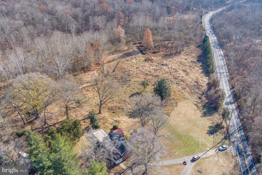 Step into the enchanting embrace of this Cape Cod-style farmhouse, nestled on an expansive 18.825-acre canvas that beckons with exceptional development prospects. Unveiling itself along Gallahan Road, the property comprises two distinct parcels.

Your journey begins with picturesque views that unfold, setting the stage for the captivating allure of this estate. The 2023-renovated brick house, strategically perched on a hill, welcomes you with a charming horseshoe driveway, instilling an immediate sense of elegance and warmth. The entire interior of the house has been meticulously updated, encompassing three full bathrooms, a renovated kitchen, bedrooms, plumbing, electrical systems, and a fresh coat of paint. A new fireplace, basement tiles, water line, and septic system enhance the overall appeal. The washer and dryer room, along with updated interior and exterior lighting, add a modern touch.

This property seamlessly blends modern convenience with rural charm, featuring storage buildings that cater to diverse needs. Mature trees grace the landscape, offering shade and tranquility, while a delightful fishpond adds a touch of serenity, creating a perfect retreat.

Convenience meets accessibility with public water and sewer services at your disposal. The strategic location, near National Harbor, Routes 210 and 95, and Washington DC, strikes a harmonious balance between the calm of rural living and the vibrancy of urban amenities. Whether you envision a private retreat surrounded by nature or dream of exploring its development potential, this farmhouse, with its expansive land, is a blank canvas awaiting your vision. Immerse yourself in the charm of country living while relishing easy access to major metropolitan areas. Seize the opportunity to claim this unique property, where possibilities are as vast as the land itself.