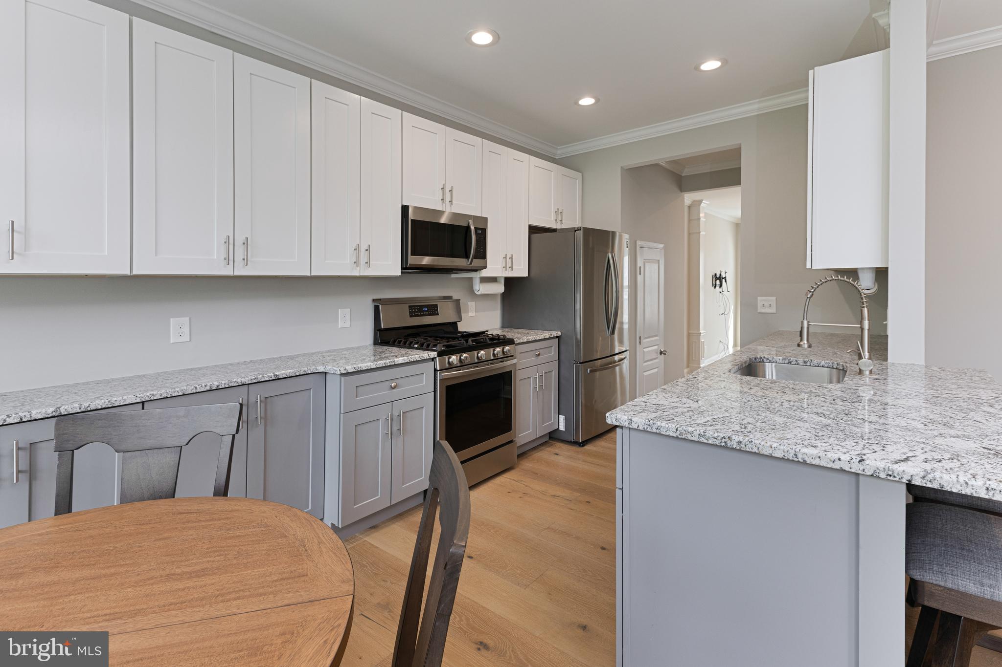 OPEN HOUSE Sunday, July 13th 1:00-3:00 PM! STUNNING 3 Bedroom / 2.5 Bath Townhome in the sought-after community of Doylestown Station—designed for buyers who value both comfort and convenience! Fully updated in 2021, this home offers a turnkey lifestyle with upscale finishes and modern amenities throughout. This BRANDON Model boasts a spacious, sun-drenched Living Room with wide plank engineered hardwood floors, floor-to-ceiling windows, and new recessed lighting. The open-concept layout flows seamlessly into a Gourmet Kitchen with granite countertops, stainless steel appliances, a 5 Burner stainless range, and striking charcoal-and -white contrasting cabinetry---all anchored by a warm, inviting Family Room with a gas fireplace with a Palladian window above. A French door leads to your private deck complete with a retractable awning—ideal for morning coffee or entertaining guests. Upstairs, retreat to your serene Primary Suite, featuring a tray ceiling, a luxurious en suite bath with a spa-style walk-in shower with rain showerhead and body jets, double vanity, and a generous walk-in closet with natural light. Two additional good-sized bedrooms, a beautifully updated hall bath, and convenient second-floor laundry complete the upper level. The finished Lower Level offers more engineered hardwood flooring, sliders to the backyard, and a plumbed closet for a future powder room—perfect for a gym, studio, or entertainment space. A spacious two-car garage includes a dedicated storage area for trash cans and HVAC access. Recent upgrades include NEWER Roof (2020) and NEWER HVAC (2022). Custom Blinds Throughout. Enjoy easy living with exterior maintenance, lawn, snow and trash removal handled by the HOA. Stroll the scenic path to Central Park’s tennis courts, Kid's Castle playground, and Summer Concerts—or take a 5-minute drive into Historic Doylestown Borough for fine dining, boutiques, and cultural experiences. With easy access to major highways, this is the perfect blend of luxury, lifestyle, and location!