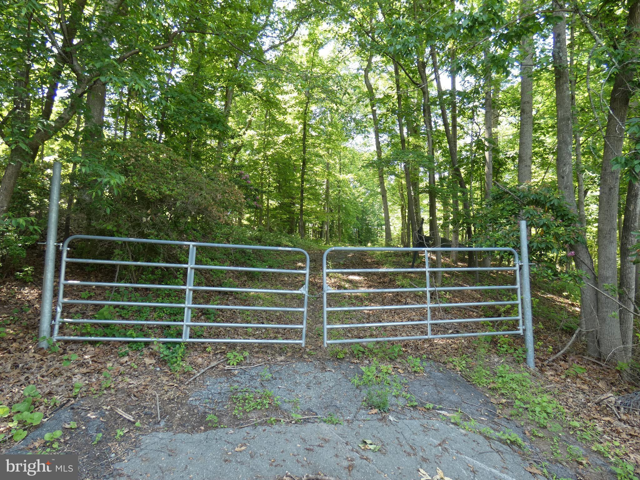 Rare opportunity to build your High-End Custom Home on a Beautiful, Private Two-Acre Lot with Park like Settings. Located in one of Bethesda's prime neighborhoods with Multi-Million Dollar Homes and is across the street from Congressional Country Club. This is a level lot that sits above the street with public utilities at the site.
