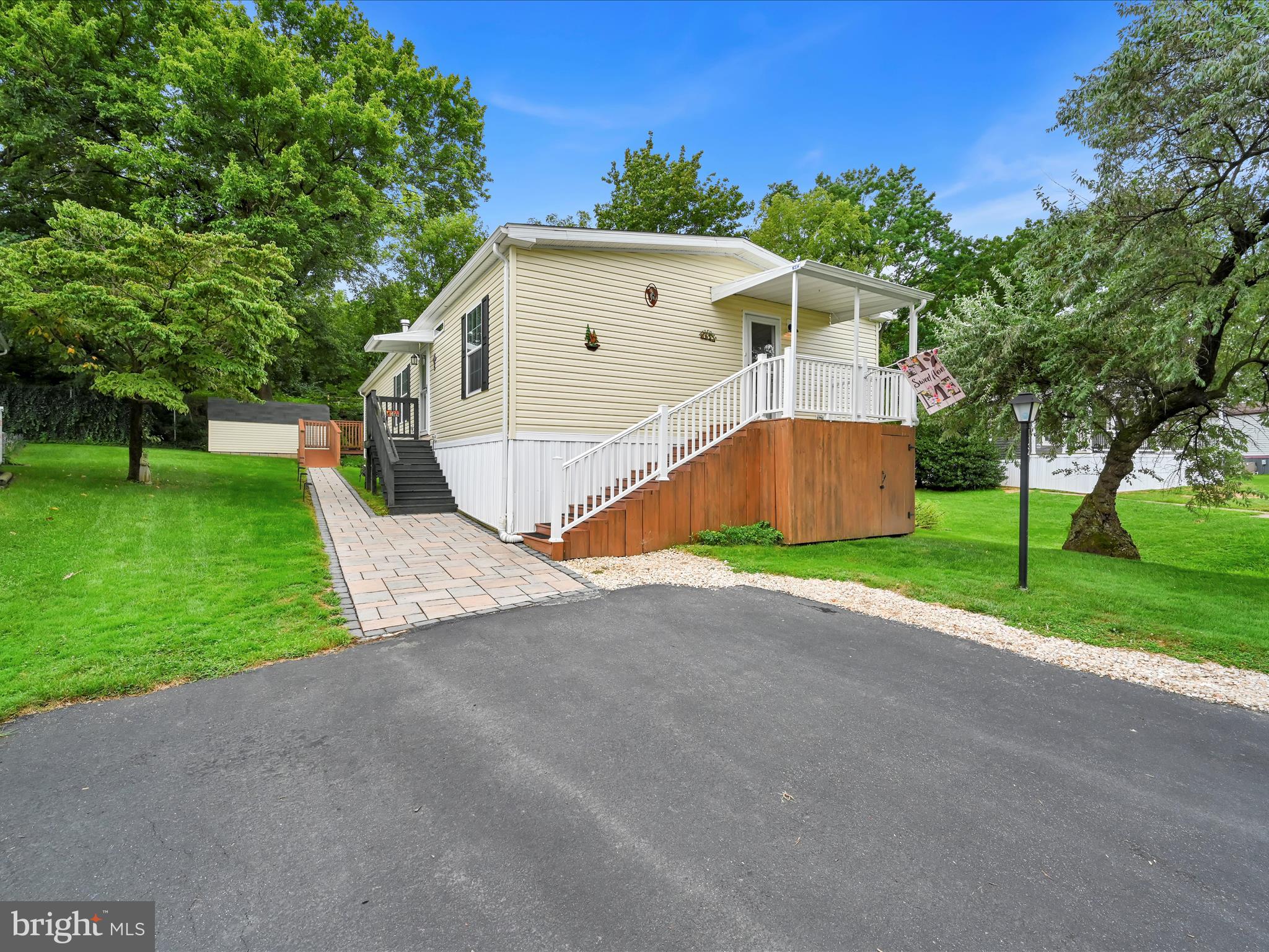 Located in the desirable Winchester Meadows 55+ community, this 2020 double-wide home offers 1,680 sq. ft. of beautifully finished living space with thoughtful upgrades throughout. Inside, you’ll find three generous bedrooms and two full baths, including a large primary suite with a walk-in closet and a luxurious 3x5 tiled walk-in shower.
The inviting open floor plan seamlessly connects the living, dining, and kitchen areas, making it ideal for both everyday living and entertaining. The kitchen features an island, pantry, and modern appliances including a built-in microwave and range. Newly installed high-density carpet adds comfort underfoot, while the remote-start propane fireplace with glass doors creates a warm and cozy focal point for gatherings.
Step outside to a large deck with ramp access, leading to a beautifully lighted hardscape walkway. A 14x10 shed with electric, along with additional storage beneath the front porch, provides plenty of room for tools, hobbies, or seasonal items. The property is equipped with a water softener system and a brand-new upgraded air conditioning unit for year-round comfort.
Backing to trees for added privacy, the lot also connects directly to the Warwick to Ephrata Rail Trail, offering over 7.5 miles of paved and stone walking paths right outside your door.
Community amenities include water, sewer, and trash service, making for a low-maintenance lifestyle. Conveniently located near local parks, schools, and recreational areas, Winchester Meadows fosters a welcoming, neighborly atmosphere with the ease of 55+ living.
Experience a truly move-in-ready home where thoughtful upgrades meet everyday convenience.