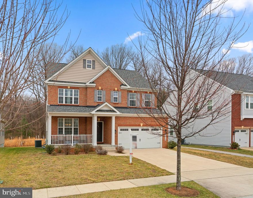 Inviting Colonial residence—the Nottingham model by Beazer Homes—offering 2,747 square feet, 4 bedrooms, 3 full baths, 1 half bath, and a 2-car garage in sought-after Centennial Overlook. A charming front porch welcomes you inside, where gleaming hardwood floors flow throughout the foyer and into the formal dining room, adorned with a chair railing, wainscoting, a sophisticated chandelier, and crown molding.  Just beyond a powder room, hardwood floors continue into the expansive open-concept family room, highlighted by a cozy gas fireplace. The adjacent gourmet kitchen features an oversized center island with a breakfast bar, sleek stainless steel appliances, ample granite countertop space, an abundance of crisp white cabinetry, a walk-in pantry, and elegant pendant lighting. A sunroom off the kitchen bathes the space in natural light, creating the perfect entertainment spot.Upstairs, a versatile loft area provides additional living space, while the well-appointed laundry room adds everyday convenience. The primary suite is a private retreat, showcasing a tray ceiling and a spa-like ensuite with dual vanities, a luxurious soaking tub, a separate shower with a built-in bench, a private water closet, and access to a spacious walk-in closet. An additional bedroom boasts its own private full bath, while two more generously sized bedrooms share a well-appointed hall bath. The lower level offers endless possibilities, serving as a blank canvas ready for your customization, complete with dedicated storage and utility rooms, as well as walk-up exterior access. Nestled against a peaceful open common area, this home enjoys direct access to Centennial Park’s scenic trails.