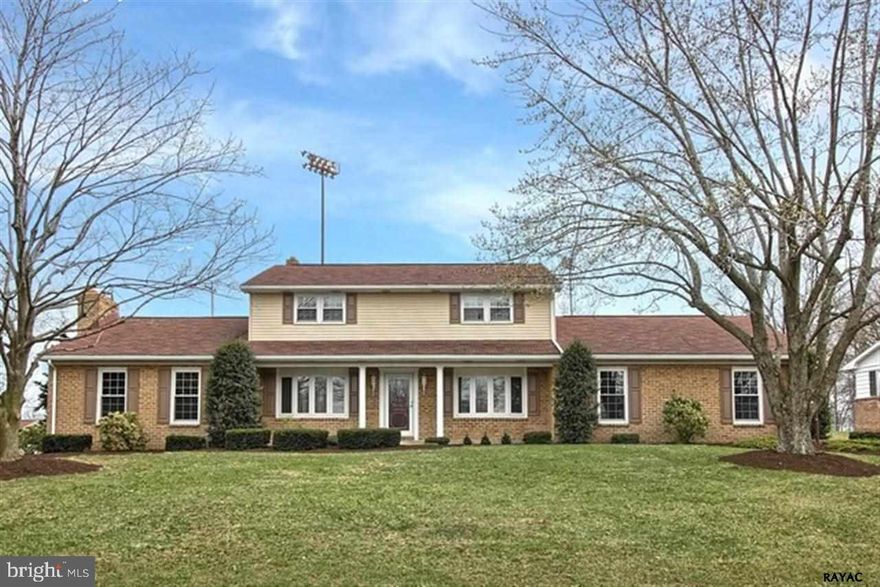 You'll be impressed w/this spacious 2 story Newer handscraped hdwd floors formal LR & DR Enjoy a fire in the stone FP in the FR or coffee in the bright sunroom Lower level includes 1/2 bath partial 2nd kitchen & another FR w/rustic beamed ceilings FP w/insert & wet bar Exterior offers gorgeous patio & mature landscaping Oversized garage for all your tools & toys!