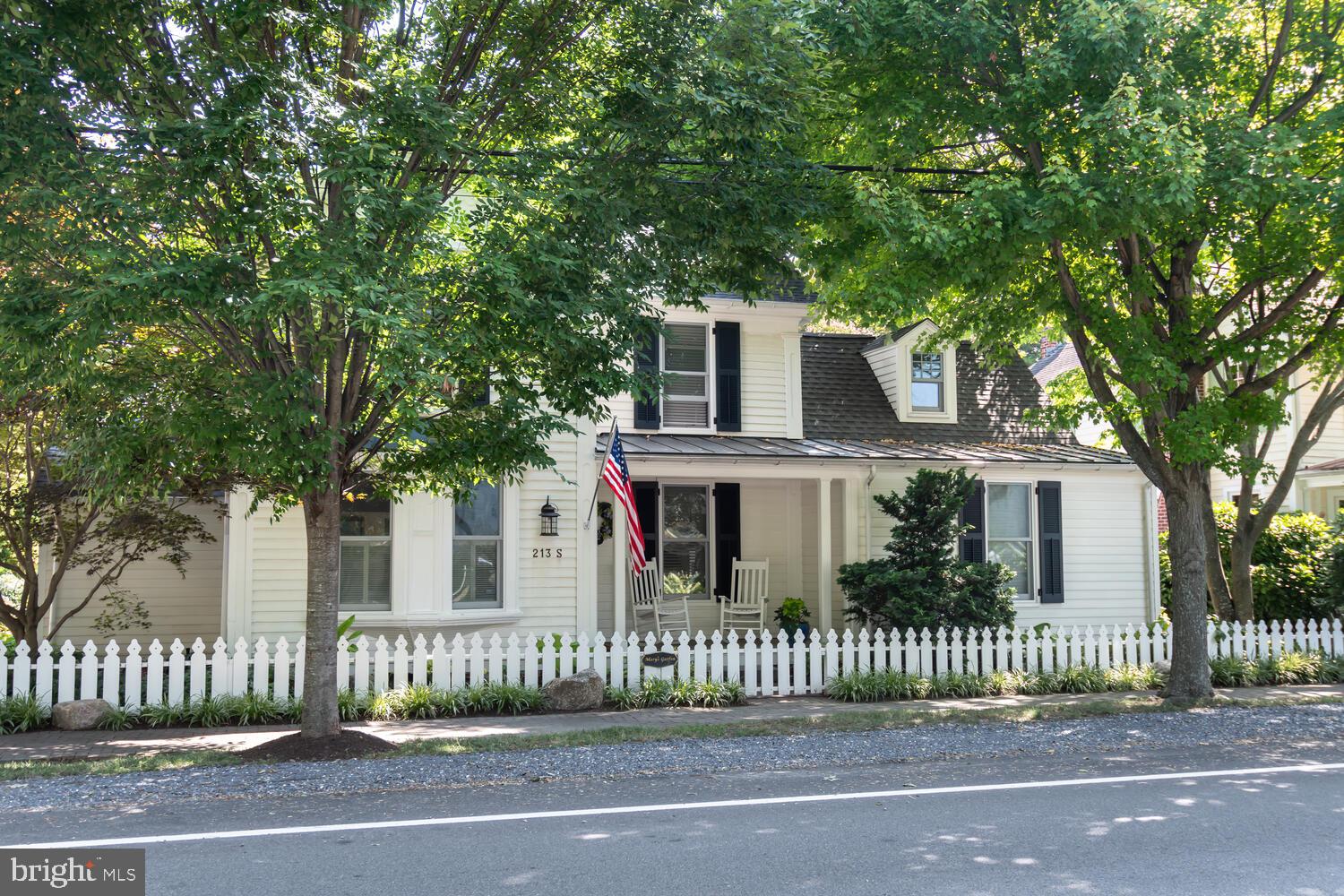 Discover the charm of 213 S Morris Street, an exquisite residence nestled in Oxford, MD's historic district. Originally built in 1870 by a skilled shipwright, this home was meticulously restored in 2006 with a "down to the studs" renovation, seamlessly blending historic charm with modern luxury. The property boasts a gravel and brick driveway, providing off-street parking, while professionally landscaped grounds and a historic brick wall ensure privacy and natural beauty in the rear and side yards. The home features a separate heated and air-conditioned studio/office, perfect for creative pursuits or remote work. Inside, the beautifully decorated interior offers a primary bedroom on the first floor and three additional bedrooms upstairs. With three bathrooms—including two on the second floor, one on the first, plus a powder room—comfort and convenience are paramount. Enjoy cozy evenings by one of the four gas fireplaces or entertain in the stunning family room that adjoins a gourmet kitchen equipped with a six-burner Wolf stove and top-of-the-line appliances. The home is bathed in natural light, with top-quality windows and doors, and features pristine pine floors throughout. It's a "happy house," radiating warmth and elegance, and its reproduction costs in today's market would far exceed the list price.