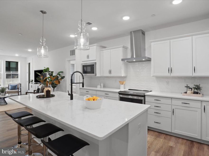 Welcome to The Flats at Waxpool Crossing — a vibrant new luxury condo community. Be the very first to call this stunning, just-completed condo “home”! This never-lived-in residence features high ceilings, luxury vinyl flooring throughout the main living areas, and plush carpet in the bedrooms for added comfort.
The open-concept kitchen includes a show-stopping island with seating and extensive prep and serving space. A beautiful backsplash and pristine cabinetry frame the upgraded GE Profile energy-efficient stainless steel appliances — including an induction cooktop and an oven with convection and air-fry settings. A spacious dining area comfortably seats six and could also be repurposed as an office.
The large primary bedroom offers two generous closets. The en-suite primary bath includes separate vanities, stylish ceramic tile, and a luxury walk-in shower. The second bedroom is also generously sized and features a large closet. The second full bath includes a tub/shower combination and bright, modern finishes.
Enjoy the convenience of in-unit laundry, abundant natural light, and a quiet, airy atmosphere throughout. Included with the home is garage parking space #1 (covered and secured with fob access) as well as storage closet #34 located at ground level.
The building offers secure fob entry leading into a welcoming social area complete with a pool table and NEW fully equipped exercise room. Residents also enjoy access to a charming dog-washing station conveniently located near the mailroom and garage entrance. Outside, beautifully landscaped common areas feature tot lots, a dog park, pavilion, and sports courts — perfect for both relaxation and recreation.
This condo delivers modern luxury, comfort, and community — all in a brand-new, move-in-ready package!
Located in highly sought-after Ashburn, The Flats at Waxpool Crossing offers easy access to major commuting routes including Route 50, Route 7, and VA-267. Dining, grocery, and shopping options — including One Loudoun and Dulles Town Center — are just minutes away.
Enjoy the ideal blend of modern convenience and community charm in this vibrant, growing area!