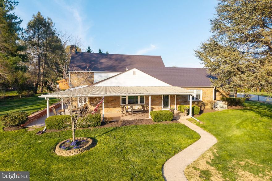 Set on a beautifully maintained half-acre lot, this charming stone Cape Cod offers a comfortable, easygoing lifestyle both inside and out. A curved walkway leads you to the front door, while the wraparound porch stretches across three sides of the home—perfect for morning coffee, quiet afternoons, or catching up with friends. Around back, the screened-in porch is a favorite spot for summer evenings, and the fully fenced yard gives you plenty of space to relax, play, or garden. The side yard features nine raised garden beds ready for vegetables or flowers, and the rear patio with a hot tub is the perfect place to unwind at the end of the day. Step inside and you’re welcomed by a bright living room with two large picture windows that fill the space with natural light. The dining room features classic wainscoting and offers a comfortable setting for both everyday meals and gatherings. The kitchen has been thoughtfully updated with wood-look tile flooring, granite countertops, stainless steel appliances, recessed lighting, and a cozy breakfast area. An added pantry cabinet provides extra storage, and just off the kitchen, the laundry area includes additional cabinets for folding and keeping everything organized. The family room, located just off the living room, is a warm and inviting space centered around a wood burning floor-to-ceiling stone fireplace. Built-in bookcases on either side add character and make it easy to settle in with a good book or enjoy a quiet night at home. Also on the main level, the primary bedroom offers two double-door closets and its own private vintage-style bathroom, where the wallpaper ties everything together with a fun mix of color. The hall bath continues with that same vintage charm, and the second bedroom on this floor is nicely sized—currently used as a home office, but with plenty of additional room for a queen bed if needed. Upstairs, you’ll find two oversized bedrooms that share a third full bath, along with a walk-in cedar closet and additional walk-in attic storage. The home feels bright and airy throughout, with multiple doors leading out to the covered porch and ceiling fans in all the bedrooms for added comfort. There are also several practical updates that make everyday living easier, including a newer HVAC system, added attic insulation, seamless gutters, and a durable metal roof designed to look like slate. The oversized side-entry garage features newer gray doors with openers and includes access to additional attic storage. Downstairs, the basement offers even more flexible space, with a finished area currently used as a game room and craft room, along with Bilco doors for easy outdoor access. Located just minutes from the YMCA and Schuylkill Elementary School, this home is also close to the heart of Phoenixville. Phoenixville is known for its walkable downtown, local shops, great restaurants, and year-round community events. Nearby spots like Reeves Park offer green space to enjoy, and the Phoenixville Public Library is another great local resource. It’s a location that makes it easy to get out and enjoy everything the area has to offer, while still coming home to a place that feels relaxed, comfortable, and truly your own. Showings begin on Friday, 4/17th.  Check out the video here on the MLS.