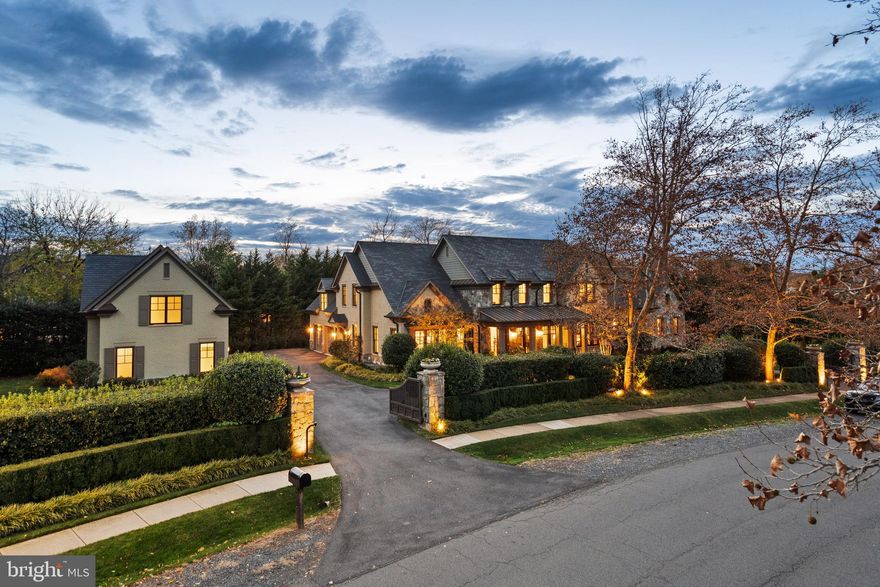 Introducing an exquisite European style estate residence in the prestigious Woodlea Mill community of McLean, Virginia. Set upon nearly an acre of meticulously landscaped grounds, this gated estate offers quiet, luxury living with unparalleled privacy just minutes from Tysons Corner and the amenities of downtown McLean.
Boasting six bedrooms, five full baths, and three half baths across 10,094 square feet of immaculately finished living space, this home provides ample room for both relaxation, work and entertainment.

The exterior reflects timeless European Style with extensive use of stone, wood timbers and brick. Inside, the warmth and character of the home is further enhanced with an open floor plan, fine fixtures and extensive millwork. The expansive kitchen and breakfast area opens to a soaring family room centered on a massive stone fireplace. A large dining room and butler's pantry easily accommodate large scale entertaining. A paneled library adjoins the music room providing a private transition to the main level primary suite, a quite oasis with views in three directions to the expansive gardens beyond. Featuring a spa-like bath, complete with a large sauna for rejuvenation and a spacious dressing room, the primary suite exudes understated opulence and comfort.

Upstairs, three bedrooms with en-suite baths adjoin a private sitting room, perfect for homework or relaxation. A separate staircase leads upstairs to a fifth bedroom or private home office, discretely positioned away from the rest of the house. Downstairs, an expansive recreation room with a fireplace and a wet bar adjoins a media room and large exercise room. A sixth bedroom with a full ensuite bath provides further accommodations for family or guests.

An attached two-car garage opens to a large mudroom and walk-in pantry for convenience, and a separate Carriage House offers additional two-car garage parking and an unfinished upstairs studio, perfectly suited for a second office or retreat.

Outdoors, lush landscaping surrounds the residence and further enhances the secluded ambiance of the property. Gather around the fire pit for cozy evenings under the stars, or simply bask in the serenity of the expansive garden, fully fenced and gated for utmost security and seclusion.

But perhaps the greatest luxury of all is the unbeatable location. Just minutes from Tysons Corner, the address offers easy access to world-class shopping, dining, and entertainment options. With major airports and all the amenities of McLean within reach, this is truly a residence that offers both convenience and privacy.

This remarkable estate offers a rare opportunity to experience refined living in one of McLean's most coveted neighborhoods, where understated luxury meets tranquility at every turn.
