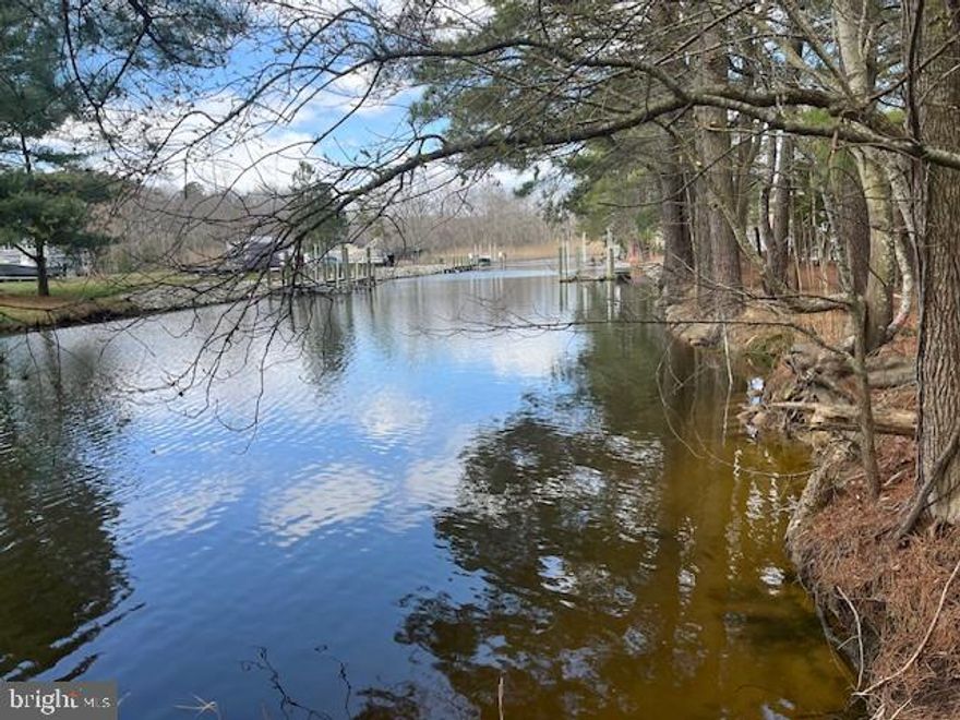 This stunning and cleared waterfront lot is located only 10 miles from Ocean City beaches! One of the last remaining waterfront lots in Holiday Harbor, and the only lot currently for sale in the community. Build your custom dream home and dock, and park your boat right out your back door. This lot is located on a navigable natural lagoon/canal and just a couple hundred yards to the St Martin River. The perfect protected location to dock your fishing boat and enjoy kayaking in the lagoon.Holiday Harbor is one of the best kept secrets in the area - it's quiet and safe neighborhood just a short drive to Ocean City and Fenwick Island beaches. And there are no city taxes or HOA fees! This is the best-value waterfront lot you will find this close to the beach!