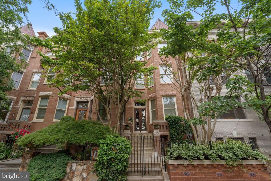 Welcome to this sensational 4-level bayfront Victorian with almost 4,000 sq ft of finished living space, 2 fabulous rooftop decks, and off-street parking in the heart of Dupont Circle!  Classic"period appropriate" charm & elegant style are juxtaposed seamlessly with modern upgrades and conveniences.  When you approach the home, you'll notice the attractive curb appeal of the perfectly landscaped and fenced front yard with mature plantings, terrace planters, and a welcoming front stoop.  The main level encompasses a grand foyer, formal living room w/gas fireplace, oversized formal dining room, powder room, a cozy family room area (brand new stair rails just installed to the 2nd stairwell to 2nd floor)  that's open to the marvelous cook's kitchen (w/premium cabinetry, granite tops & ceramic tiled backsplash, stainless steel appliances), and exit door to the backyard/parking area.  The second level has a large primary bedroom suite (w/fireplace & sitting room area), a primary bath (w/separate shower & tub, double vanity/sinks, and closets), hall laundry closet, 2nd bedroom, full hall bath (w/shower), 3rd bedroom w/rooftop deck access, and back stairs to the family room/kitchen.  The third level has an open family room (or it could be a guest bedroom) with a gas fireplace, full bath, office area, double closet, and an exit door to the incredible main rooftop deck (w/pergola and planter boxes).  The separate, recently renovated lower level in-law suite/apartment (with front & back entrances) has a brand new fully equipped kitchen, combination LR/DR with gas fireplace, 2 bedrooms, a full bath, washer/dryer closet, and a shared storage/utility room.  Additional notable features/amenities include:  9'10" ceilings throughout the main level, hardwood floors, double paned replacement windows, newer energy efficient boiler/water heater (radiators), energy efficient HVAC/heat pump system (forced air providing heat & central air), repointed exterior brick, and automatic watering system.  Only steps away to the Dupont Circle Metro,  retail shops, a plethora of restaurants and other great attractions that Dupont Circle provides.