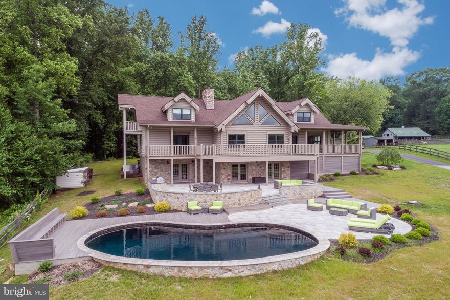 This TRUE ONE-OF-A-KIND log home is a dreamy, private country retreat w/ modern polish! Stunning outdoor space w/ salt water pool, travertine & Trex tiered patio & al fresco dining area w/ built-in LION BBQ & granite island. LL is an Entertainer's Dream w/ huge Wet Bar & an open, versatile floor plan that walks out to the patio. Custom 5-car garage with all the bells and whistles