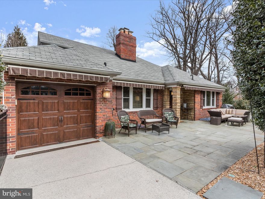 Large, impeccably maintained brick and stone home with garage on a 1/3-acre lot with mature shrubs and trees – a quiet sanctuary, close to all that the metropolitan area has to offer. With a large flagstone patio and pergola in the front of the home, an expansive rear deck and a spectacular 3-season porch, this home offers multiple spaces for gracious entertaining with picturesque wooded views.
On the first floor, a library/study off the foyer has stairs to a private bedroom with built-in bookshelves and ensuite marble bath. This beautiful upper-level bedroom also has a sitting area, two closets, under eave storage, and enjoys its own heat pump for heating and cooling. 
Down the main level hallway, a spacious living room with large windows and gas fireplace overlooks the back yard.  The kitchen, open to the dining room, is updated with maple cabinets, granite countertops, hot water dispenser and oversized stainless sink, and a new KitchenAid range and soon to be installed KitchenAid refrigerator. A door from the kitchen opens to the garage making it very easy to transport groceries and shopping bags. A door from the dining room leads to an expansive all-weather porch with wood floors, walls of windows and skylights with shades, and a mini-split heat pump makes year-round entertaining comfortable – a great space for hosting Thanksgiving dinner! Two first-floor bedrooms include a primary bedroom with updated ensuite bath featuring double sinks, marble floor, a sunken tub and separate shower. The hall bath is new and has been tastefully renovated with a stunning shower which features a tiled ceiling and two shower heads.
The finished lower level, completely above ground, includes a walkout to a deck overlooking the rear patio and backyard and a second flagstone patio in the rear yard. The deck enjoys protection from the elements due to the porch that was built above it. Inside, a stunning family/rec room with gas fireplace, partial kitchen, exercise room and full bath offers great space for movie nights, exercise or guests. The laundry area features a washer and two dryers. Many updates include a furnace, water heater and whole house generator, all less than three years old.
Located between Connecticut Avenue and Jones Mill Road, this home boasts a fantastic location just inside the Beltway and a short ride to Washington, DC, downtown Bethesda, the Town of Kensington, Strathmore Music Hall, Nature Forward and Rock Creek Park. Enjoy wonderful space, beautiful views, and proximity to everywhere you want or need to be. Welcome home!