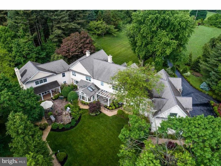 Nestled away at the end of a long private drive, this breathtaking, immaculately maintained executive estate is everything you’d hope for when picturing life in the rolling hills of Chester County. Set on 3.4 bucolic acres in the award-winning Unionville-Chadds Ford School District, this property is ideal for those who value privacy, tranquility, and green space. This open concept, light and bright mansion blends thoughtful privacy with timeless elegance, offering 8,700+ square feet above grade and over 2,000 square feet of outdoor living spaces with sweeping views of the surrounding greenery. From the moment you arrive beneath the stately portico and wrap-around porch, the warmth and craftsmanship of this home are on full display. A marble foyer with turned staircase, mahogany railings, and custom wainscoting sets the tone for what’s to come. Entertain in style in the formal dining room, where a bay window perfectly accentuates the setting sun. The living room, with its cozy wood-burning fireplace, connects to a private office—both spaces offering floor-to-ceiling windows and captivating views. The kitchen is bright and functional with newer stainless-steel appliances and a gas cooktop, while the vaulted solarium—a unique and special area, opens directly to the outdoor patio, fireplace and built-in gas grill. For more relaxed evenings, the den offers a second wood-burning fireplace and leads into a spectacular two-story family room with radiant heat, a stunning arched stone fireplace, wet bar, and French doors to the backyard—an entertainer’s dream setup. Guests or an au pair will love and appreciate the private staircase leading to a separate bedroom with marble bath. In the main upper level, the expansive primary suite boasts a cathedral ceiling, ambient fireplace, sitting area, and dual walk-in closets. The luxurious primary bath features travertine tile, granite-topped double vanity, a Jacuzzi tub, and separate shower. Also on the second level is a second private office, several additional generously sized bedrooms, three full baths, and a massive 47’ x 20’ recreation room with 11' vaulted ceilings—perfect for play, study, or fitness. In the basement, movie nights come alive in the theater room with full surround sound, and a truly welcoming atmosphere. The strikingly beautiful, thoughtfully curated outdoor living areas evoke the charm of an English countryside estate, with meandering paths and impeccably maintained gardens with lush shrubbery. There is ample space for entertaining or sports on the surrounding grounds, with plenty of open grounds left to add your own custom finishes to make this one-of-a-kind property your own. Lastly, to allay any remaining buyer concerns, the Sellers are offering a comprehensive home warranty to accompany your purchase, providing total peace of mind.   This is a home designed for living and entertaining at the highest levels. If you value space, privacy, craftsmanship, and attention to detail tantamount to none, then you need look no further. Additionally, the new owners have the option to purchase 736 Northbrook as well (a 1.736 acre buildable lot) simultaneously or in the future if they wish. Properties that offer this much opportunity and versatility rarely come into fruition anymore--schedule your tour today before it’s gone.