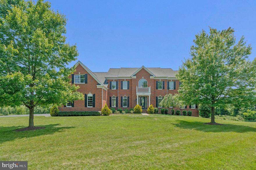 Perched atop more than 5 private acres, this breathtaking luxury estate offers panoramic rolling mountain views from every room.  A truly remarkable home where every detail has been thoughtfully curated to perfection. This Toll Brothers Henley Model in the sought-after Waterford Ridge community in Loudoun County's Waterford, VA has it all! 4 Bedrooms, 5.5 Bathrooms, over 7000 finished sqft, sideload 3 car garage and over $100k in builder structural upgrades. Designed to impress and built to last, the home welcomes you with a dramatic grand double staircase and soaring ceilings that set the tone for elegance throughout.
Expansive living spaces flow effortlessly, featuring custom finishes, gorgeous wide plank hard wood floors, floor-to-ceiling windows, and refined architectural details. The grand two-story great room, soaring 30 feet high and showcasing an elegant five-stage coffered ceiling and a striking gas fireplace, creates a stunning backdrop—especially magical for holiday decorating. The large sunroom gets lots of natural light and is the perfect place to watch the sunset in front of the second fireplace.  The gourmet Palladium Kitchen is a chef’s dream, featuring a sprawling quartz island, GE Monogram stainless steel appliances, custom cabinetry, and stylish, on-trend lighting that brings both function and flair to the heart of the home. From the main kitchen area, step outside onto the brand-new Trex deck—perfect for dining al fresco, entertaining guests, or simply taking in the peaceful surroundings. 
Upstairs, you’ll find four generously sized bedrooms, each with its own private ensuite bath, offering comfort and privacy for family and guests alike. Three of the bedrooms have their own private sitting room. The owner’s suite is a true retreat—an elegant sanctuary featuring a spacious spa-inspired bathroom with a large soaking tub, separate shower, 2 separate toilets, three walk-in closets, and a private dressing room. With ample room to relax and recharge, this luxurious suite offers the perfect escape at the end of the day.
The walk-out lower level offers an exceptional space for entertaining, whether you're hosting lively gatherings or enjoying cozy family game nights. It features a private media room, a full bathroom, and opens to a brand-new flagstone patio—an ideal setting to relax and take in the breathtaking sunsets.
This property offers the perfect blend of privacy, space, and stunning Loudoun County views. Surrounded by nature, it provides endless opportunities for wildlife watching—deer, foxes, birds, and more are frequent visitors, making every day feel like a retreat into the countryside. It’s a rare opportunity to enjoy serene, scenic living without sacrificing convenience—ideally located within 15 minutes from downtown Leesburg, 30 minutes of Dulles International Airport, the Dulles Greenway, and an array of shopping, dining, and some of Virginia’s finest wineries and breweries. Roof Replaced in 2025.