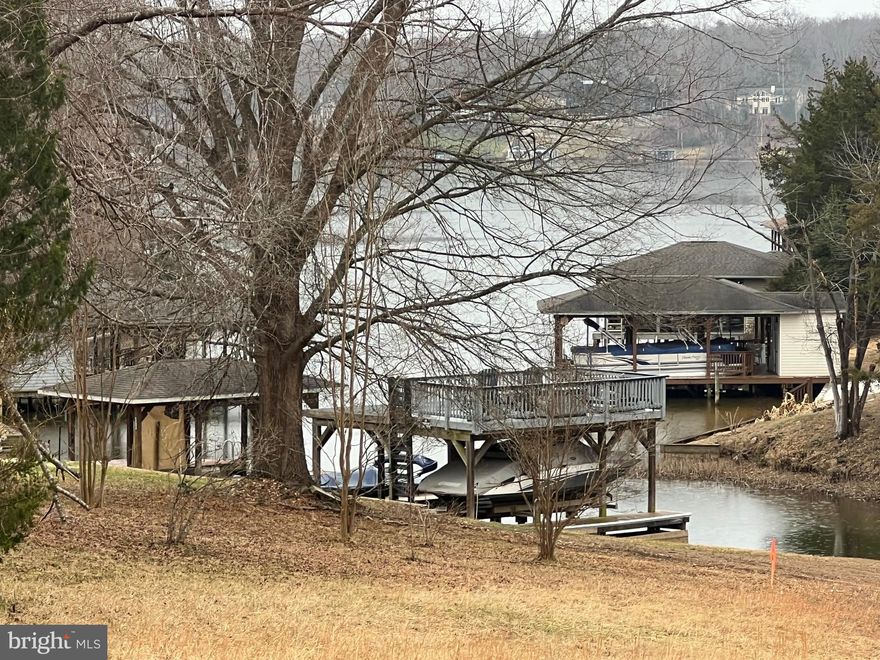 Shared waterfront lot with a slip in the sought-after neighborhood of Rose Valley. Gently sloping and mostly cleared, the lot offers a prime building location. Boat slip #5 conveys with the property. Located mid-lake, there is easy access by boat to the lake's many restaurants: The Cove, Tims, and the Tap House. It's also a short drive to the off-lake amenities, Food Lion, DG Fresh, Local Wineries, and Breweries. A great opportunity to have waterfront living at an affordable price.