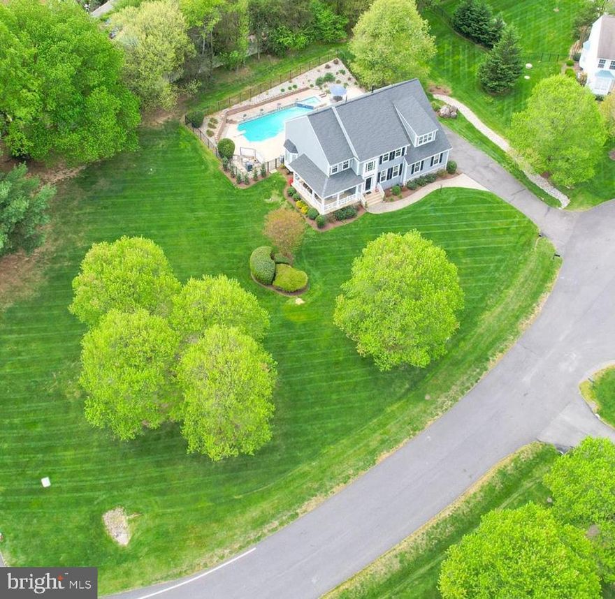 Get ready for summer!  This spectacular pool home was built for year round fun with an inviting outdoor oasis complete with deck, extensive hardscaping, and an enormous (.99 acre) flat lot that is perfect for lawn games!  Located on a quiet cul-de-sac of semi-custom homes, this idyllic neighborhood feels like country living with large lots, plenty of green space and even a view of horses and a red barn, yet it is minutes from every convenience.  From the moment you enter the cul-de-sac, you will be charmed by the stunning curb appeal of this home complete with a wrap around porch and side load garage.  The original owners have maintained this home impeccably over the years with more than $400K in updates.  The flowing floor plan  offers a huge great room as the focal point of the first floor with a floor to ceiling stone fireplace that opens to a "WOW" custom kitchen with a walnut island, farmhouse sink, chef's range with gas 6 burner cooktop and hood, plus plenty of cabinets and counter space.   The main level also features a library and formal living room and dining room that offers optional flex space if a more casual lifestyle is desired.  The upper level boasts the desirable 4 bedrooms and 3 full bath combination.  The spacious primary suite offers a renovated spa bath, sitting area and large closet space, the spacious guest room has an ensuite bath and the 2 additional generously sized bedrooms share a hall bath.  The lower level features another fun zone with a fully outfitted wet bar with custom live-edge countertop, a shuffleboard table that conveys, a work out space, and a non-egress "5th bedroom"/den and full bath.  This home has it all and is in the coveted Crossfield Elementary, Carson Middle and Oakton High pyramid.  Perfectly located with easy access to major commuter routes - 50, 66 and 267, minutes to the Dulles Airport, Silver Line Metro, shopping and restaurants at Reston Town Center, Tysons and Fairfax Corner.  Updates include - Primary Bath Renovation & Additional Upper Level Bath  (2023), Roof, Windows, Hardie Plank Siding & Garage Doors (2019), Custom Kitchen (2018), , Trex Deck (2015), HVACs (2012 & 2014).  Offer deadline Monday, April 29th at 5pm.