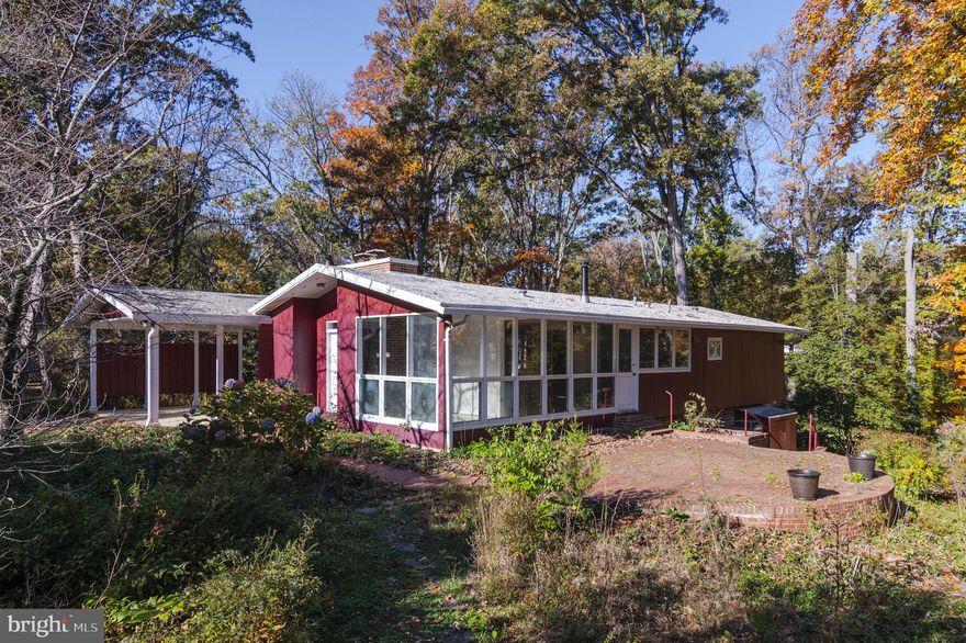 Welcome to this quintessential mid-century modern gem located in the highly sought-after community of Hollin Hills.  The main level of the home boast walls of floor-to-ceiling windows allowing nature to become your decor. The bedrooms also feature floor-to-ceiling windows flooding the rooms with natural light and making for unparalleled views of nature. Downstairs you'll find plenty of room for entertaining and walk-out access to the large backyard.  The home has two working fireplaces and a large storage room with a full-size washer and dryer as well as a 2 car carport.