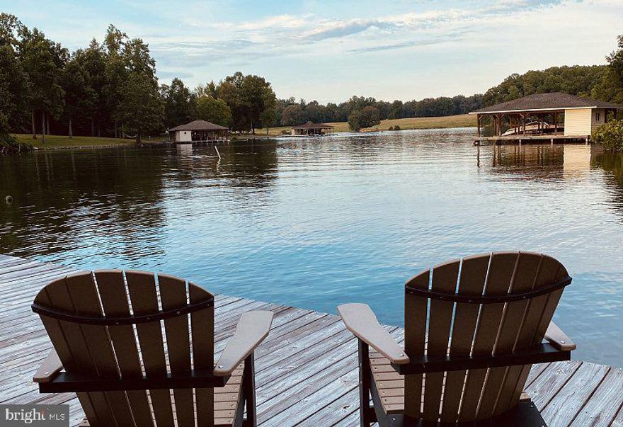 Have you ever wanted to build your own LAKE HOUSE? Here is your opportunity, this FLAT lot comes with a BOAT SLIP and is now available in a VERY QUIET, & FRIENDLY NEIGHBORHOOD! The area for the house has been cleared, it has perked for a 4-Bedroom home and the soil test was performed in 2021. Fiber Optic work to begin in the Fall of 2024.  This lot is one block off the water and is a level lot with beautiful mature trees! This lot is conveniently located just 6 minutes from Food Lion and within 15 minutes of these other local popular establishments: THE COVE, CALLIE OPIES ORCHARD, COOLING POND BREWERY AND WINERY, COYOTE HOLE CRAFT BEVERAGES/VITO'S ON LAKE ANNA, LAKE ANNA TAPHOUSE AND MUCH MORE! *****  Here's some Information on this gorgeous neighborhood:  FRESHWATER ESTATES is Nestled in the heart of Virginia, Freshwater Estates is a lakeside community of properties, all either waterfront or with access to the lake. The community includes a common area, where a boat launch, boat slips, and a picnic area are located. Freshwater Estate boasts "We're a community of Lake Life individuals and families." Come & see for yourself! *****
MORE ABOUT LAKE ANNA: it is one of the largest freshwater inland reservoirs in Virginia, covering an area of 13,000 acres, and located 72 miles south of Washington, D.C., in Louisa and Spotsylvania counties (and partially in Orange County at the northern tip). The lake is easily accessible from Fredericksburg, Richmond, Charlottesville, Northern Virginia, and Washington, D.C., and is considered one of the most popular recreational lakes in the state. Lake Anna is approximately 17 miles long from tip to tip, with 200 miles of shoreline. The lake is divided into two sides: the public side (also known as the "cold" side) and the private side, working as a cooling pond (also known as the "hot" side). The public side is roughly 9,000 acres, while the private side is roughly 4,000 acres. The private side is formed of three main bodies of water, connected by navigable canals. The public and private sides are divided by three stone dikes. The private side has no marinas or public access ramps; only property owners and North Anna Power Station employees have access to the waters on the private side. The public side has several marinas and boat launches, including a boat ramp at an adjacent state park. The public side sees significantly higher boat traffic compared to the private side, especially on summer weekends. The public side is known as the "cold" side because it provides water to cool the generators at the power plant; the private or "hot" side receives warm water discharge from the power plant. The private side can be substantially warmer than the public side, especially near the discharge point, where it can be too hot for swimming. The private side has an extended water sports season. Some water circulates back out of the private side into the public side through underground channels; consequently, the public side is warmer in the southern area near the dam. In the winter, some fish migrate to these warmer waters.