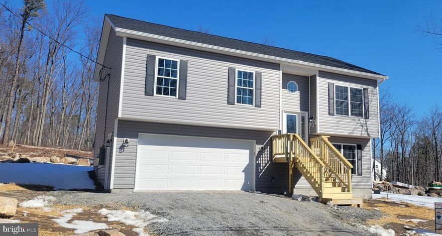 Welcome to this beautiful 3-bedroom, 2-bathroom split-level home, a brand-new build nestled on a spacious 0.28-acre lot in the Mountain Falls Park community.  Enjoy a warm welcome with a cozy covered porch. Inside, the home features luxury vinyl plank flooring throughout, providing a modern, durable finish. The kitchen is a chef's delight, with stainless steel appliances, premium shaker-style cabinets, and sleek granite countertops that add both style and functionality. The primary bath offers a touch of luxury, with granite countertops and a convenient stall shower. Each bedroom has thoughtfully designed built-in shelving in the closets, adding extra storage and organization. The lower level boasts a spacious family room, perfect for gatherings, as well as a convenient laundry room. For vehicle storage and projects, the oversized 21 x 23 two-car garage provides ample space. Outside, the Mountain Falls Park community offers amenities, including a common area, lake, picnic area, playground, and more—ideal for outdoor recreation and family fun. This stunning new home combines comfort, style, and a scenic location.