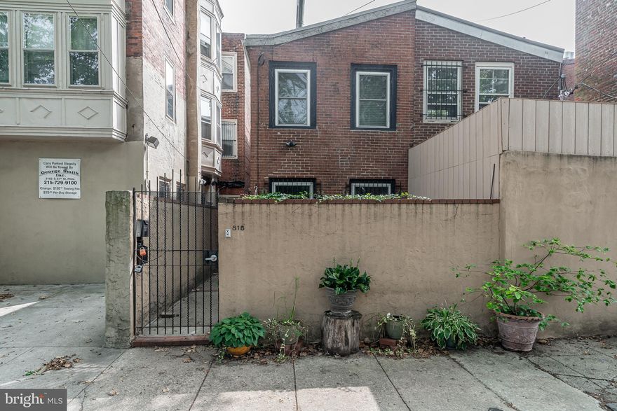 This spacious, gated condo absolutely oozes character from top to bottom. Enter from the quiet back-street, and pass through the tranquil outdoor patio space, where you will enjoy peace and privacy as you relax and entertain. Walk inside, and you are met with a jaw-dropping living space boasting two exposed brick walls, track lighting, eye-catching flooring, and a wood-burning fireplace for those cozy winter nights. The darling kitchen offers a second wood-burning fireplace, gas cooking, and tile flooring. Up the sleek staircase, you will find two bedrooms with painted exposed brick and high vaulted ceilings, a charming hall bath, and a convenient stacked washer and dryer. Right in the heart of Queen Village, you will be in the coveted Meredith Catchment, plus you are steps to myriad shops and restaurants. Not to mention, quick access to the riverfront and I-95. Schedule your showing today!