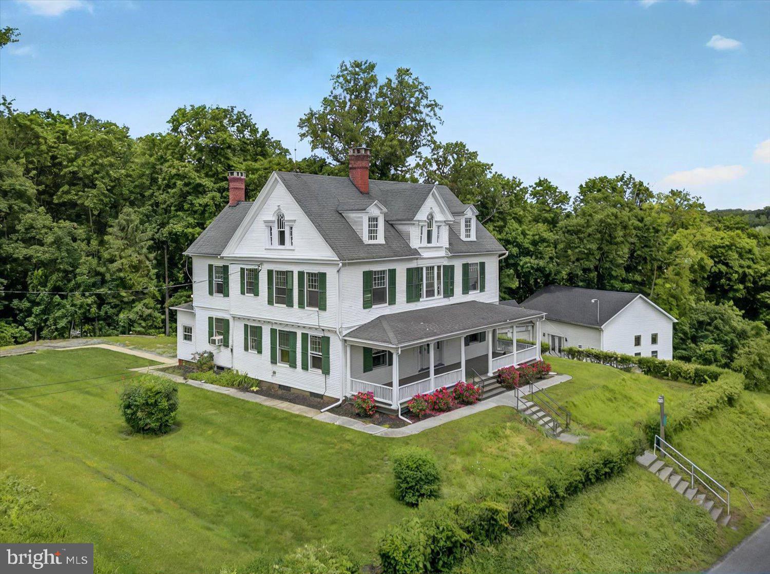 A rare opportunity to restore and reimagine. Welcome to this timeless estate on over 3 acres of land, offering over 3,000 sq ft of classic charm. This home features a wrap-around porch, multiple detached garage bays, an incredible workshop, and a stunning two-story stained-glass window. A rare blend of space, character, and history that can be yours! Offered at $350,000, this won't last long, schedule a tour today.