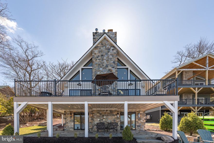 Welcome to breathtaking, fully furnished tranquility on Lake Harmony. 138 South Lake Drive is truly the rare opportunity to park, open the front door, and enjoy 2024 on the water. Completely reconstructed, reimagined, and redesigned by award-winning Stonewood Interiors.  This three-level 3250 SF masterpiece sleeps 12, has 3 full bathrooms, parking for 6 vehicles, a redesigned 2-car garage, and two expansive levels of outdoor space only 15 steps to the water's edge.  Exquisite finishes throughout including a soaring 2 story family room with views of the lake, chef's kitchen, spa, bathrooms, state-of-the-art mechanical security systems, and a lower level perfectly created for entertaining or as a kid's paradise.  Prominently located on the south shore of Lake Harmony with arguably the finest view of the lake, this unique property is being sold including all fixtures, furnishings, and systems.