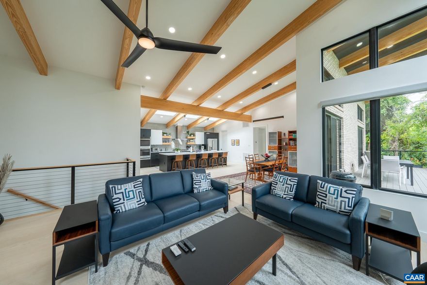 To Be Built ? Customizable Mid-Century Modern Gem in Downtown Charlottesville  Don?t miss this rare opportunity to create your dream home in the heart of Charlottesville. Just two blocks from the vibrant Downtown Mall, this to-be-built Mid-Century Modern masterpiece blends timeless architectural elements with the comforts of contemporary living.  Featuring 4 spacious bedrooms and 4 full baths, the home offers a thoughtful, open-concept layout with abundant natural light throughout. Skylights above the kitchen illuminate airy, modern living spaces, while expansive walls of glass blur the line between indoors and out.  Striking wooden ceiling beams run throughout the interior and seamlessly extend over the outdoor deck, which is accessible from both the dining area and the luxurious primary suite?perfect for relaxing or entertaining.  The finished basement provides even more room to live, work, and play, featuring a spacious recreation area, home gym, and a stylish kitchenette/bar?ideal for entertaining guests, hosting game nights, or creating a comfortable in-law or guest suite.  All this in a premier location?walkable to restaurants, shops, galleries, and more.   Agent is owner of the parcel