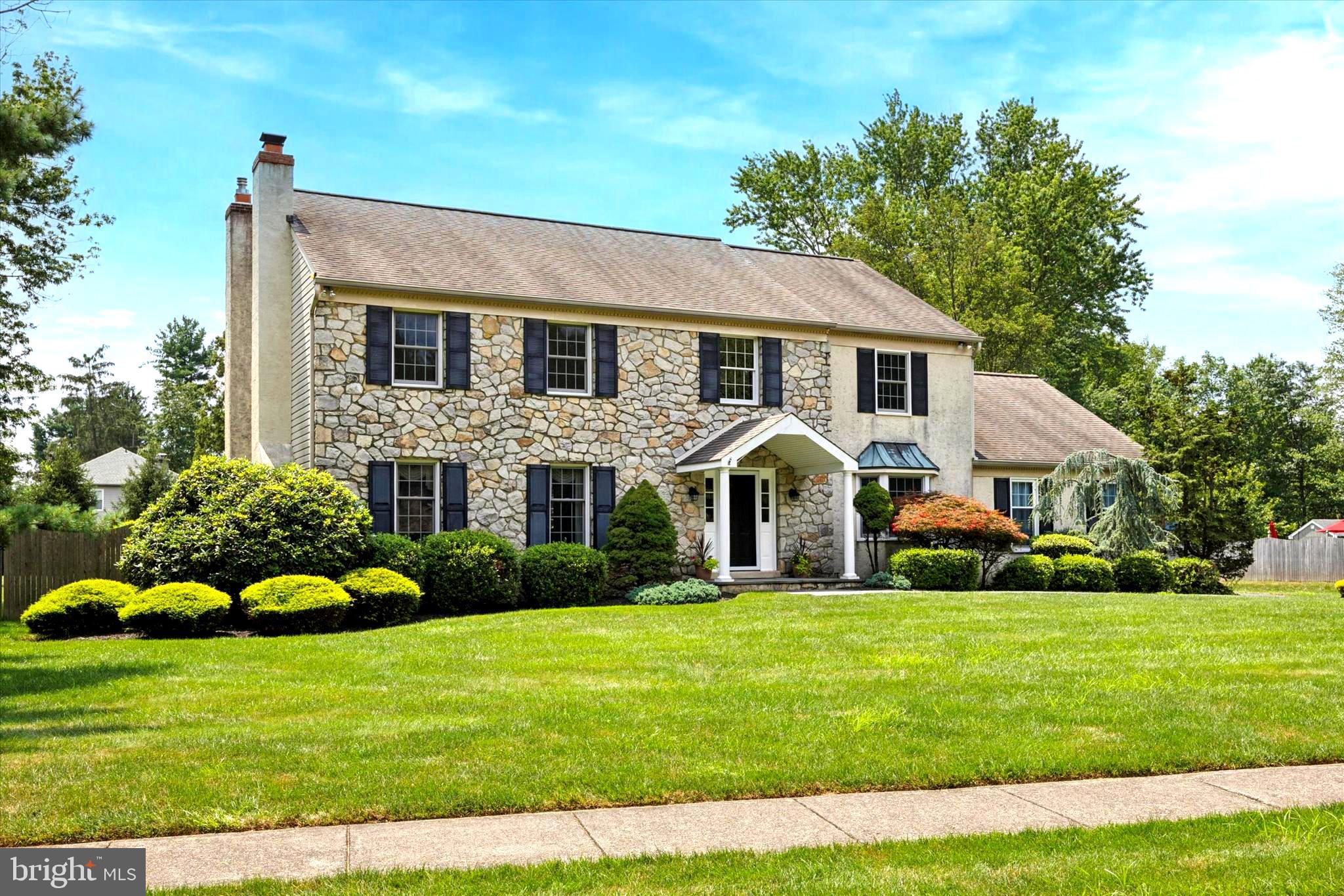Welcome to 1010 Pheasant Meadow Road - a stunning traditional home nestled on nearly an acre in the heart of Blue Bell. This exceptional home offers elegant curb appeal with lush landscaping and mature trees, creating a private oasis that feels like your own retreat. Step inside to find a warm and inviting foyer with rich hardwood floors that flow throughout the main level. To your right, the formal dining room is a showstopper with its large bay window, classic wainscoting, and crown molding- perfect for entertaining family and friends. To the left, a formal sitting room features exquisite custom millwork and a wood-burning fireplace with a handsome marble hearth, offering a refined space to relax or entertain. The home opens seamlessly into a generously expanded living area where you’ll find a stunning family room with cherry wood built-ins, a gas fireplace framed by rich millwork, and a large bay window that overlooks the EP Henry covered patio. At the heart of the home lies the chef’s dream kitchen—thoughtfully designed and expertly equipped with high-end stainless steel appliances, including a Wolf stove, Viking double ovens, trash compactor, beverage fridge, and a built-in wine rack, all pulled together by a crisp subway glass tile backsplash. The two-tiered granite island offers both a prep area on the lower level, and a casual seating on the upper level- need more prep space? Head over to the well appointed prep island conveniently located in front of the ovens with an extra sink. There’s also a pantry, custom lighting, an abundance of cabinetry and counter space, and a soaring Palladian window that floods the space with natural light and offers breathtaking views of the backyard. A sliding French door leads directly from the kitchen patio, complete with three skylights, offering a shaded escape ideal for outdoor dining and entertaining. Additional first-floor highlights include a laundry room with a sink, a tastefully appointed powder room, and access to an oversized two-car garage with room for storage or a workshop. Upstairs, a spacious landing leads to the luxurious primary suite, which features a large bonus room with custom built-ins- perfect for a home office, nursery, or private gym. The suite also includes two walk-in closets with an extra storage area, and an en-suite bath with a double vanity. Three additional well-sized bedrooms, all with generous closet space, share a neutral hall bath. The unfinished basement offers exceptional storage; easily finished to meet your needs. Step outside to discover a backyard sanctuary: an expansive patio, beautifully landscaped grounds, and a sparkling pool with an integrated spa—all tucked away in total privacy. Whether you're lounging poolside, enjoying a summer barbecue, or listening to music through the home’s built-in sound system, this backyard delivers the ultimate escape. Located in the award-winning Wissahickon School District and just minutes from major commuter routes like Route 202, 309, the PA Turnpike, and the Blue Route, this home offers both convenience and tranquility. Schedule your private tour today.