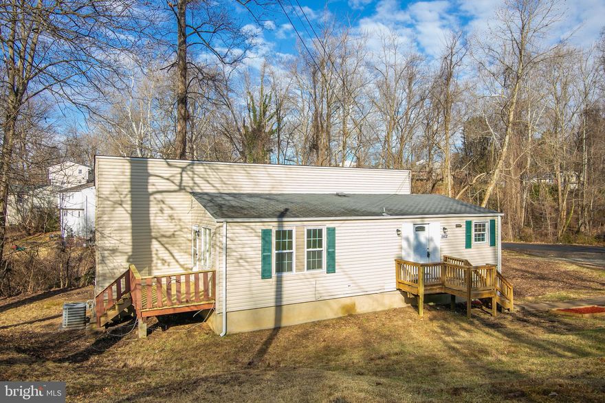 This contemporary home has 4 levels; 2 large bedrooms on top level with full bath and 2 bedrooms on separate level with full bath.  Kitchen and living room on main level and basement level with rec room and full bath.  Recessed lighting, new carpet, 3 decks!  Circular driveway.
Sales price includes an additional lot:  19018 Barnette Circle for almost 1/2 acre. See plat for possible home site or garage!.  Just minutes to Quantico and I-95 for easy commuting.