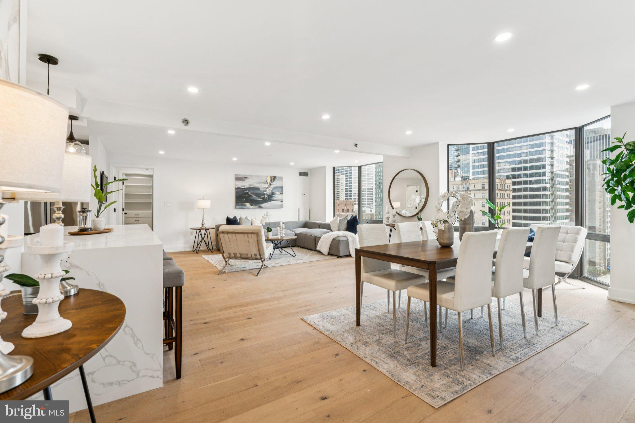 Brand new two bedroom, two bathroom with panoramic sunrise views over Center City. The home is the combination of two adjacent one bedrooms, creating a space with a generously proportioned floorplan featuring an oversized great room, wood floors, an open chef's kitchen with island, split bedrooms, luxurious primary suite, contemporary bathrooms, floor-too-ceiling bay windows, in-unit laundry and excellent closet space. High end finishes include GE appliances, quartz countertops, stylish cabinetry, modern vanities, beautiful tilework and custom closets. No detail was left undone!
The Wanamaker House is located one block from Rittenhouse Square and provides easy access to both Center City and University City; residents enjoy a 24-hour doorman, a seasonal rooftop pool, a fitness center, and a parking garage available for an additional fee (subject to availability). All common areas were recently renovated including the lobby, hallways, meeting room, amenity lounge, and fitness center, designed by world-renowned architect Cecil Baker.
