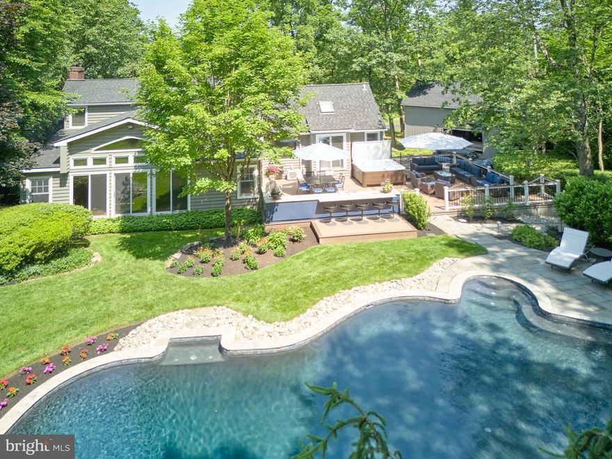 Valley Road, is a pastoral road with beautiful homes, open land and an equestrian facility. Sited on this country road is ValleyView, a sophisticated home that has been tastefully renovated over the years. The current owners have installed  a new oil tank, furnace, roof, pool plaster, pool pump and generator...just to mention a few. All of the improvements were installed with style and quality that add to the overall
aesthetics of the home. The interior has been painted in all of the correct colors that today's home buyers'
desire. Although this is an older home, the floor plan flows seamlessly from the original home to the new addition. The living room with fireplace greets you with inviting warmth and the adjacent formal dining room is filled with natural light. The rear solarium room, with walls of glass, offers a  brick pattern ceramic tile, an impressive stone wall and a large bar that demands festive gatherings.  The primary bedroom boasts a cathedral ceiling and a grand primary bath with cathedral ceiling and designer tile. The other bedrooms are ideal for family or weekend guests.  During warmer weather, there is an oversized deck that
comfortably contains different seating areas and a beautifully constructed kitchen with large grill, refrigerator, sink and burner top. The granite countertop covers the entire length of the kitchen. There is an al fresco bar area that all of your guests will covet.  The property is lushly planted with major specimen shrubs and trees that envelop the newly plastered heated pool and provides a sense of tranquility and privacy. The home contains a two-car garage plus an artfully designed detached structure perfect for extra garage space, work shop or major storage.  The dimensions on this structure are  31 W x 25 D and 12’ to ceiling joists.   ValleyView is a rare find among the sea of center hall colonials that dominate the marketplace today. ValleyView is the home you need to see.