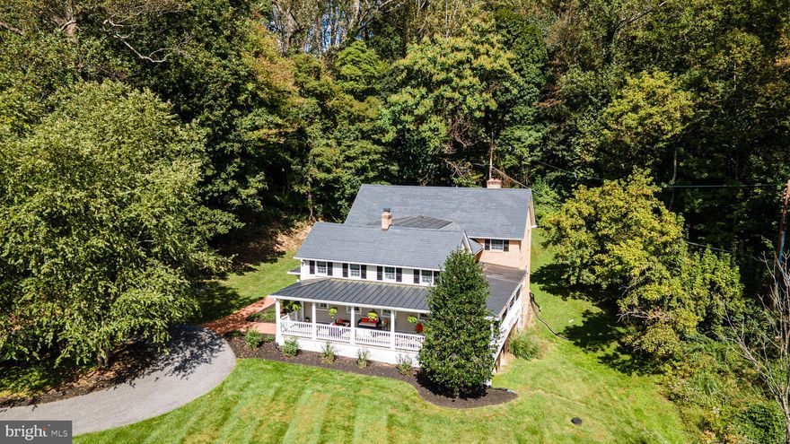 Nestled in the rolling hills of Greenspring Valley, 2628 Greenspring Valley Road offers timeless charm and modern sophistication in one of Maryland’s most coveted enclaves. This private retreat on 0.6 acres is enveloped by mature landscaping, creating a quiet, tranquil setting adjacent to Greenspring Valley Country Club.  An expansive wraparound porch (40' x 38') sets the stage for mornings with coffee and evenings overlooking the valley’s gentle slopes. Recent updates, including a full porch rebuild (2019), freshly painted shutters and siding (2022), and thoughtful landscaping, make the outdoor spaces as functional as they are inviting.  Inside, sun-filled rooms flow easily from everyday living to entertaining. Fresh paint, updated appliances (2024), and two fireplaces bring warmth and style, while upstairs, four bedrooms include a primary suite with spa-like bath. Modern upgrades: a water softening system (2022), new well tank (2019), and updated chimneys (2017), provide comfort and peace of mind.  A true Greenspring Valley gem, this home offers privacy, natural beauty, and an effortless connection to the neighborhood and just minutes from Baltimore.