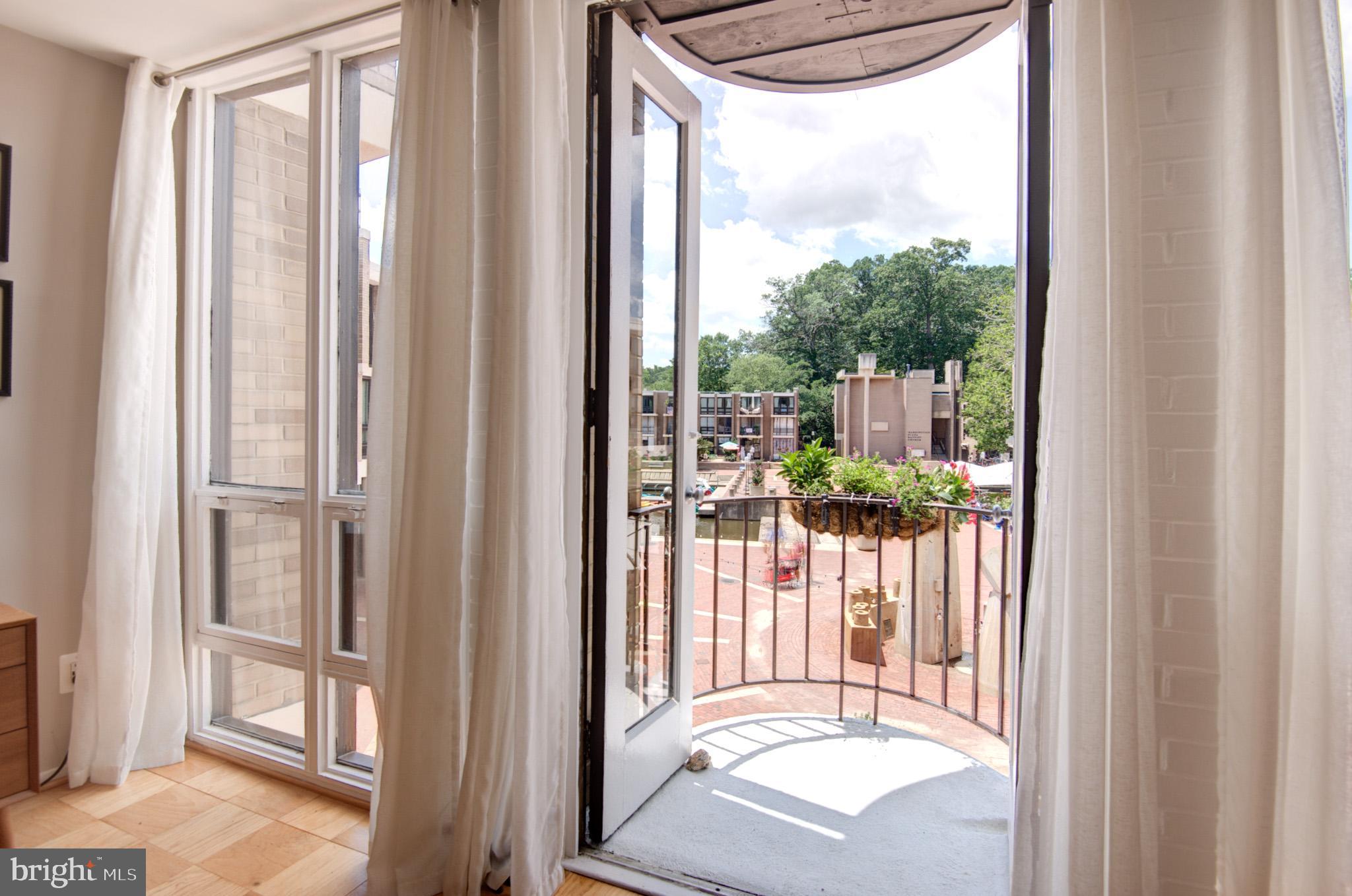 OPEN HOUSE SAT 7/26 12-2PM! Lake Anne Reston lifestyle at its very best! Lake Anne was the first Village Center built as part of founder Robert E Simon’s vision. Today, the plaza sits in an Historic Overlay District and is home to a diverse and vibrant community, locally owned businesses, community amenities and fine dining. Come experience living local at Lake Anne Plaza in Reston Virginia! Walking up to this perfectly situated condo, you know you’re going to be in for something special. Enjoy hanging out outside on the patio with a glass of wine or a morning cup of coffee. As you enter, you can look directly through the condo to the back with floor to ceiling windows. Open up the French doors at the back and you are instantly transported to Paris! The balcony overlooks this uniquely European styled plaza with numerous shops, restaurants, coffee and tea establishments and lovely restaurants. Add a lake view and a fountain view and you have complete perfection! In addition to the view that everyone is looking for, this condo has been tastefully updated and includes impeccable original wood parquet flooring, an opened up kitchen with stainless steel appliances, remodeled bath and closets, stunning stone fireplace and several other updates for today’s buyer!
Did I mention you that this condo is also just steps from the Saturday Reston Farmers Market in spring summer and fall? And that it faces west and offers lovely sunset views? Did I tell you that all utilities except cable are included? Close to the Metro, Lake Fairfax Park, the W&OD Trail and the Reston Town Center with all of its amazing shopping, dining and nightlife, you have the perfect location!
Don’t miss this great chance to become part of a very special and historic neighborhood… it’s a lifestyle!