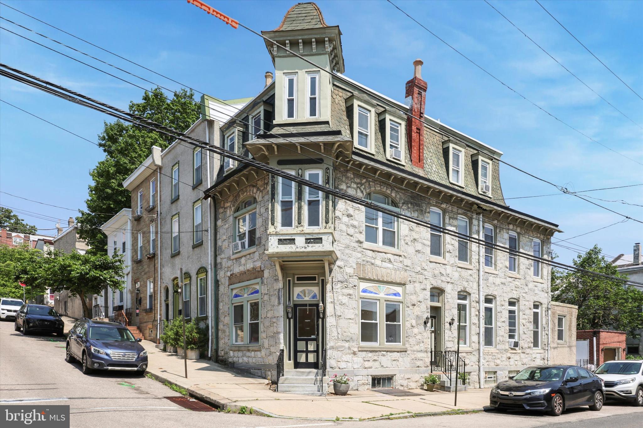 BACK ON THE MARKET. YOU STILL HAVE A SHOT! This is a must see corner property in Manayunk/Roxborough, with loads of local history. All the space you could want or need, walkable to Main Street, easy commute to Center City and nearby Wissahickon Neighbors Playground. 5 Bedrooms, 3 Full Baths WITH A GARAGE.
The expansive footprint and stone exterior are expressive of a home built in aprx 1900. Enter into a foyer/mudroom and you will notice the high ceilings throughout the entire home. With some creativity, this could be the grand entryway you have always dreamt of. Large windows with intricate trim shed natural light throughout every inch of the home. The floorplan offers flexibility of layout to fit the needs of any buyer. With several rooms on the first floor currently presented to include, Living Room, Dining room, Kitchen, Office, Laundry Room and foyer - The space also offers potential to create an exceptional open floor plan.
The second floor offers two large bedrooms. One bedroom features corner view windows looking out over Manayunk and a large cedar closet. Another absolutely flooded with sunlight and space. A hall bathroom with built in linen closet serves these rooms.
The landing and stairs to the third floor add elegance to the home and exemplify the amount of space it has to offer. The third floor offers a (not photographed) spacious bedroom with ensuite bathroom. Two additional bedrooms complete the floor. Hardwood floors throughout.
Out back is a patio area perfect for grilling and dining under the stars as well as the private 1-car garage. Whether you plan to park in the garage or store your bikes, THE GARAGE IS A HUGE BONUS.
The property was most recently used as a rental. While it will be delivered vacant, in its present condition, it was rented for approximately $4200/mo. A whole lot of space, room to increase your equity, a neighborhood treasure and zero doubt that this would be a fantastic investment. Next door just sold for $639k without a garage.