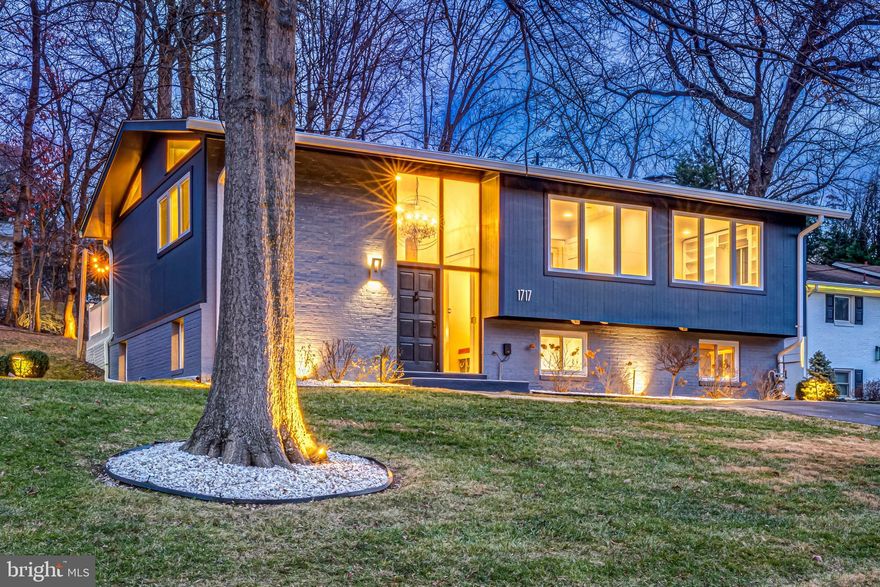 Architectural, light-filled, and beautifully renovated, this modern McLean residence blends mid-century character with refined contemporary design. Vaulted ceilings, expansive windows, wide-plank wood floors, and custom solid-wood interior doors create a warm yet elevated living environment.

The chef’s kitchen is both striking and functional, featuring a Wolf range, sleek cabinetry, quartz countertops, and a large picture window that floods the space with natural light. Exposed brick adds subtle texture, while the adjoining living and dining areas showcase a custom accent wall and seamless access to a spacious deck overlooking mature trees—ideal for indoor-outdoor entertaining.

Spa-quality bathrooms feature Porcelanosa fixtures, custom tilework, frameless glass showers, pebblestone flooring, and boutique hotel lighting. A water filtration system with reverse osmosis provides clean, purified water throughout the home.

The main level offers three bedrooms, including a serene primary suite with a large picture window and modern detailing. One secondary bedroom includes a custom built-in bookshelf, while another features a dedicated study area—ideal for work or school. Thoughtful layouts and clean architectural lines create spaces that feel both functional and refined.

The lower level provides exceptional flexibility with space for a family room, office, gym, or playroom, along with a spacious laundry room outfitted with full cabinetry for ample storage and a highly functional workspace. Two additional bedrooms on this level offer ideal accommodations for guests, extended family, or private office use.

Outdoors, the private yard is framed by crepe myrtles, boxwoods, and hydrangeas, with landscape lighting illuminating the front, back, and sides of the home to create a warm, inviting ambiance day and night. Modern infrastructure upgrades include a dedicated EV charging station and a 17kW backup power generator, providing efficiency, convenience, and peace of mind.

Situated on a quiet street in the heart of McLean, the home offers quick access to Tysons, Washington DC,  major commuter routes, top-rated schools, and the newly reimagined Chesterbrook Shopping Center. A rare designer-renovated property with thoughtful upgrades throughout—truly move-in ready and one of a kind.