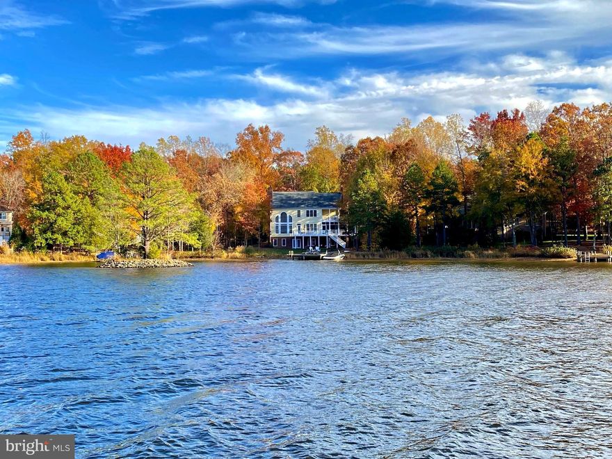 The epitome of idyllic waterfront living, this gorgeous lakeside Dream Home is located within Fawn Lake, one of Virginia's most prestigious gated resort-style communities. Featuring a coastal inspired interior with a semi-open floor plan filled with timeless architectural details, luxury finishes and modern amenities at every turn, this residence was designed for casual lake living and the ultimate waterfront lifestyle you have been dreaming of! 
Featuring stacked porches, this Southern Coastal Colonial with nearly 4,500 SQ FT is perfectly nestled in a quiet cove boasting unobstructed views of the water in a setting that is both peaceful and breathtaking. Combining privacy, luxury, tranquility, and capturing the essence of coastal lakeside charm, this lakeside retreat embraces the allure of waterfront living with light-filled spaces oriented to maximize panoramic water views from nearly every room!  
Upon entering, you are immediately drawn to the spectacular two-story Great Room brimming with natural sunlight from the dramatic wall of windows that offer breathtaking views of Fawn Lake.
A welcoming Foyer with board and batten walls and wood floors is anchored by a formal Dining Room with large windows and a beautiful Study. The Gourmet Chef's Kitchen boasts beautiful white cabinetry, a large center island, Quartz countertops and stainless steel appliances.  The light-filled breakfast area featuring walls of windows is the ideal setting for enjoying meals and taking in breathtaking lake views.
An adjoining cozy sitting area flows together and creates the perfect space for casual living and entertaining.  Glass Doors grant access to an amazing and inviting Screened Porch with a wood-burning fireplace for cool evenings, and the expansive Deck.  Both offer incredible lake views and abundant opportunities for seamless outdoor living, dining, lounging, and entertaining. 
A true sanctuary, the private Owner's Suite with large windows, features a beautiful spa bath with dual vanities and tile shower. A private balcony offers a perfect spot to relax and unwind while enjoying the peaceful and serene lake views.  A gracious Bedroom en suite with a private Bath and balcony access, plus two additional Bedrooms with walk-in closets and a shared Full Bath offer ample accommodations for family and guests.  A convenient laundry room completes the upper level.  
Designed for entertaining, the walk-out Basement features stunning lake views and a Recreation Room with a custom Wet Bar, complete with beverage fridge and floating display shelves. A gracious Bedroom with large windows and an awesome adjoining full bath, make an ideal guest retreat. French doors provide access to the covered patio and the backyard oasis. 
A beautiful lawn with lake-fed irrigation features a boardwalk leading to the water's edge with 112 feet of coveted shoreline, and the expansive private boat dock, which offers plenty of space for sunbathing and enjoying the incredible sunsets. Imagine swimming or fishing right from your dock and hopping on your boat, kayak or paddle board to explore the pristine waters of Fawn Lake.  
Whether entertaining or savoring quiet, everyday moments, this extraordinary residence provides a perfect backdrop for creating lasting memories, embracing the magic of Country Club life, and enjoying the ultimate waterfront lifestyle at Fawn Lake!
***The beautiful Luxury Fawn Lake Community offers amazing amenities such as a boating recreational lake, sandy beach, an Arnold Palmer designed Golf Course, tennis courts, baseball and soccer fields, dog park, volleyball courts, walking trails, Community Club House, marina, fitness center, restaurants, Country Club, playgrounds, and so much more! Located in the countryside near the town of Fredericksburg, surrounded by park lands and only a few miles to the farm market, wineries, and award winning breweries! Conveniently located to shopping, restaurants, top-rated Riverbend District schools and I-95!