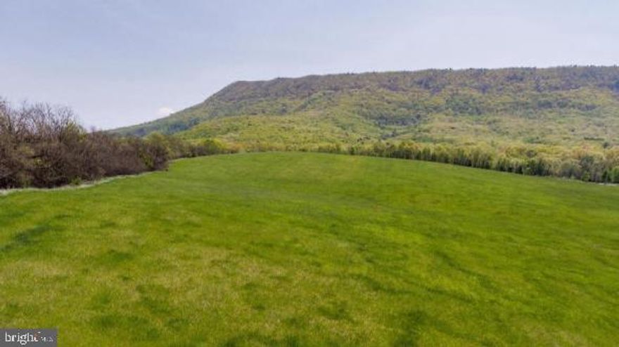 MULTI-MILLION DOLLAR VIEWS from this 3.533 acre hilltop lot. The owner has released for sale, acreage from one of the most coveted and scenic locations in Strasburg (some may say all of Shenandoah County)….…Sandy Hook Farm.     
The elevation of this lot provides both mountain and sweeping valley views, where you’ll feel like you can practically reach out and touch Signal Knob.   Have your blueprints ready as the property is cleared, a Certification Letter for a well and 4 Bedroom septic is on file and electricity is already onsite and installed.   Break ground now and prepare to watch the seasons change including the leaves turning to brilliant colors in the fall from the vantage point of your new home.
Elementary, Middle, and High schools are within a 2 mile radius.  Outdoor enthusiasts will love the proximity to the Shenandoah River, fishing, kayaking, hiking, biking, and all things nature.   Historians will be drawn to an area rich in history and tradition.   The Shenandoah Valley is a growing area for tourism.   Wineries, restaurants and local culture abound.   
This location offers the best of rural living while remaining convenient to commuter corridors I81 (4.2 mi), I66 (10 mi), Washington DC (60 mi), area industrial parks and major employers including Mercury Paper, Thermofisher Scientific, Valley Health System, Navy Federal Credit Union, FEMA, Axalta, Rubbermaid, and Amazon Distribution to name a few.   Air travel is also convenient as the area is served by 3 major airports, Dulles International and  Reagan National Airports and BWI.  
Whether you’re relocating to the area for career or retirement or have lived close-by all your life, acreage on Sandy Hook Farm offers the place to build and live your dream!