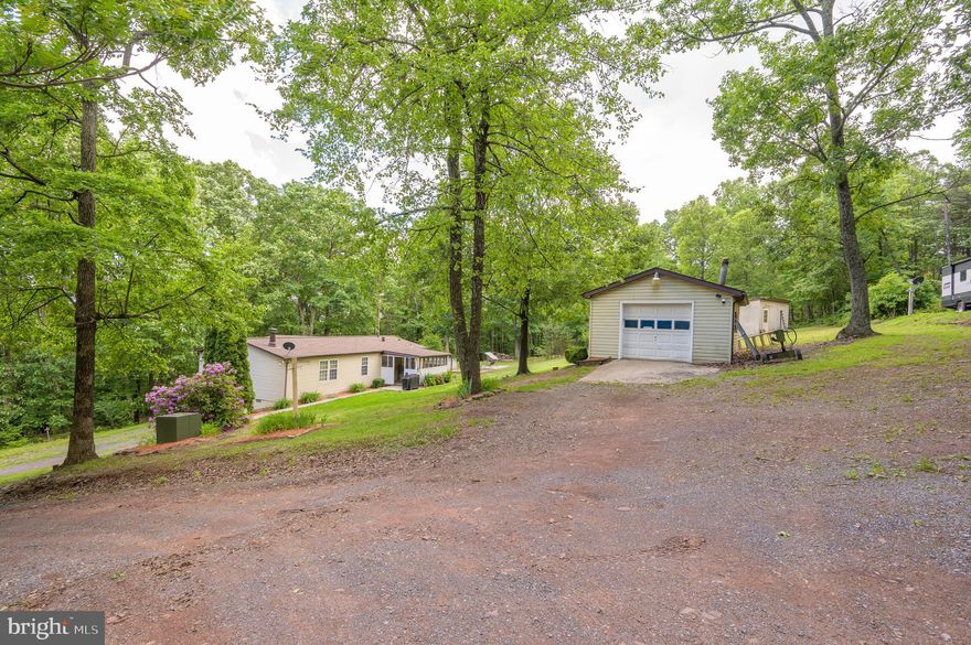 Take advantage of this exceptional opportunity to own 3.57 unrestricted, private acres on a state-maintained road (Thurman Dr.), where adventure and tranquility await! Step right from your property into nearly 23,000 acres of Sleepy Creek Wildlife Management, offering limitless outdoor activities like hunting, fishing, and exploring. As an added bonus, enjoy the convenience of high-speed fiber optic internet. This well-maintained home features a spacious primary bedroom with an en-suite bathroom, a second bedroom, and another thoughtfully designed bathroom. The open floor plan is perfect for comfortable living, with a cozy den that invites you to unwind by the wood stove, surrounded by the charm of deer antlers from your own hunting trips. Whether you're relaxing on the covered front porch or screened-in back porch, you'll be able to savor the peace and serenity of your surroundings. A detached garage offers plenty of storage space or room for your hobbies, complete with a 30-amp breaker box, and a shooting range setup on the hill offers the perfect spot to practice during the off-season. There’s plenty of room to hone your bow skills too, and additional sheds are available for storing wood or other essentials. Recent upgrades include a roof that’s less than five years old, a new pressure tank and well pump installed in December 2024, and both the backup oil heat and the central heating and air conditioning system, all replaced less than three years ago. Whether you're looking for a year-round home or a perfect getaway during hunting season, this property offers an extraordinary chance to live the life you've always dreamed of.