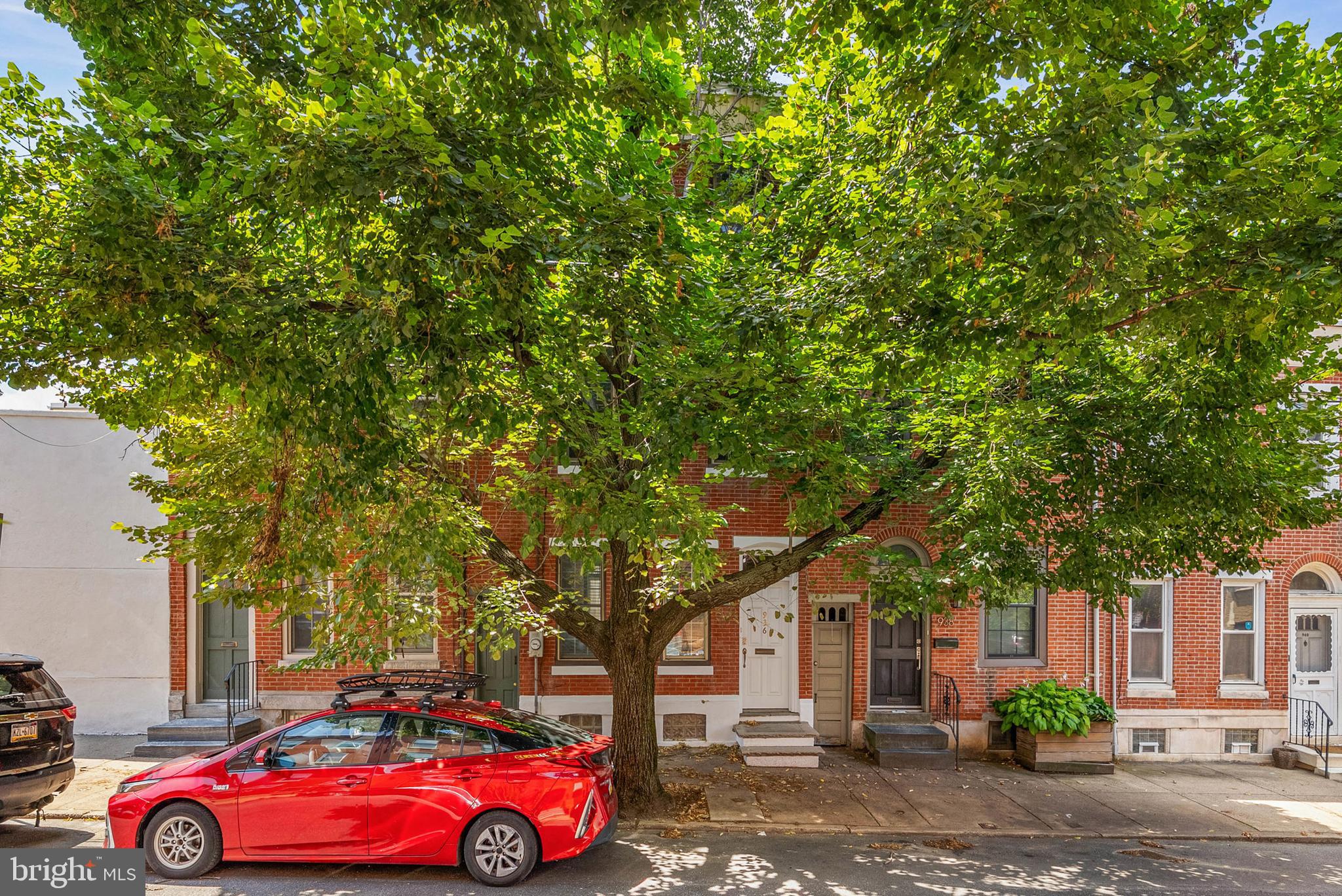 Experience the best of city living at 936 N 4th Street! This huge, 3-story home offers 3/4 spacious bedrooms, 3.5 bathrooms, a finished basement, outdoor spaces off each level, and a prime, walkable location in the heart of Northern Liberties. Out front, the classic red brick facade is shaded by a lush, mature tree. A vestibule with a coat closet welcomes you inside. To the left, high ceilings and modern floors extend across the open, airy living room and dining area. There's plenty of space for hosting family and friends or enjoying a cozy night in around the fireplace. Past a convenient powder room, the sunlit kitchen features lots of shaker cabinetry, granite counters, stainless steel appliances (including a double range), a tile backsplash, and a breakfast nook overlooking the rear patio. Stepping out back, you'll find a quiet oasis that's sure to be a popular spot for summer barbecues and al fresco dining. Plus, there's access from the street for easy entertaining. More living space is provided in the finished basement, perfect for a home theater, guests, or playroom, along with a full bathroom and storage closets. Up on the second level, large, sunny bedrooms sit on opposite ends, flanking a full bathroom and a laundry room. A deck is off the rear bedroom. Topping off the home is a private primary suite boasting two walk-in closets, a deck, and a full bathroom with a double vanity and a dual-head shower. In addition to everything inside, this fantastic Northern Liberties location earns a Walk Score of 91! The surrounding blocks are filled with top-rated restaurants, local businesses, and lively entertainment. Sprawling parks are nearby, plus neighboring Fishtown has more to explore. There's also easy access to public transit, I-676, I-95, and South Jersey. Schedule your showing today!