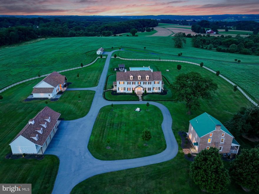 Live authentically. Overland Farm, circa 1845, a fully realized historical estate offering 96 +/- serene acres amid the pastoral hush of Baltimore County. A rare opportunity to embrace a life well-lived... from refined country living to equestrian pursuits or vineyard ambitions. Panoramic views stretch in every direction. The 2017 manor home serves as the estate’s foundation, blending refined simplicity with purposeful architecture. Warm intimate interiors and framed vistas in the distance. Craft culinary wonder in the well-appointed chef’s kitchen... the heart of the home. An opulent primary suite unfolds with scale and elegance, offering a luxe spa bath creating a sanctuary of rest and retreat. An impeccably appointed lower level... perfect for social occasions or everyday relaxation. Four elegantly covered porches extend the living experience beyond the interior, providing welcoming transitional spaces that embrace your daily rhythms. Imbibe under the stars and revel in the 45,000-gallon gunite saltwater pool with a sun-drenched patio and shaded pergola. Peace is not a moment, but a presence.
Party on in an Amish built party barn... the crown jewel of entertaining spaces—complete with a half bath. Exposed beams, soaring ceilings and a plethora of possibilities. Park with ease in the expansive five-bay garage, currently configured to accommodate four vehicles, with the fifth bay thoughtfully transformed into an integrated workshop... perfect for hands-on projects or creative pursuits. Host family and friends within the distinguished brick guest house, thoughtfully renovated in 2011. Whether it's for a weekend or an extended visit, your guests will delight in the sunlit interiors and the effortless comfort that makes this space feel like home. Additional fencing and a run-in shed enhance the farm’s functional charm.
Overland Farm is located within Long Green Valley National Register Historic District.
Overland Farm is on the Baltimore County Landmark List. 
A legacy estate crafted for generations to gather, celebrate, and create joyful experiences. Located just minutes from Jacksonville's village conveniences and within easy reach of the beltway, Hunt Valley, and I-83. Verizon Fios Internet. Cultivate your existence. The art of uniting human and home.

• Please note - The total count of bedrooms, full and half bathrooms in the Manor House and Guest House have been combined in the listing. Breakdown is as follows:
Manor House - 4 Bedrooms, 5 Full Baths, 1 Half Bath
Guest House - 5 Bedrooms, 2 Full Baths, 1 Half Bath