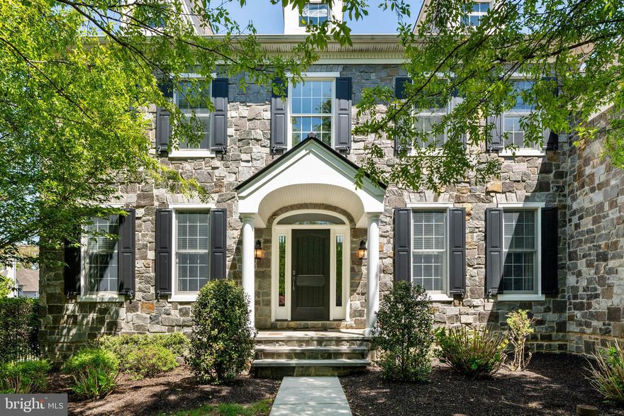 Situated on a desirable premium homesite and located on one of Liseter’s most coveted streets, this stately stone-front home offers a seamless blend of timeless elegance, modern functionality, and exceptional lifestyle convenience. Enjoy picturesque front-to-back green views and easy walkability to the park and ponds, fitness center, recreation barn, trails, pool, and sport courts within the prestigious enclave of Liseter.  A grand, sunlit two-story foyer with a sweeping staircase creates a commanding first impression, flanked by refined formal living and dining rooms adorned with freshly painted trim. Graceful arches throughout the first floor enhance the home’s sophisticated architectural character, while softly gleaming hardwood flooring extends throughout much of the home. Designed for both everyday living and effortless entertaining, the open floor plan unfolds into a stunning two-story great room featuring a dramatic stone fireplace and filled with natural light. At the heart of the home, the chef’s kitchen features stainless steel appliances, granite countertops, a large center island with seating, and spacious walk-in pantry storage. The main level is completed by a private study, powder room, secondary staircase, and a spacious laundry room with utility tub and exterior access. Upstairs, hardwood flooring throughout the entire second floor, a wide hall highlighted by sophisticated wood balusters leads to four generously sized bedrooms. The luxurious primary suite  a spacious sitting area, three custom-shelved walk-in closets, dressing/vanity area, and a spa-inspired bath featuring a serene soaking tub, double vanity, glass-enclosed shower, and private water closet. One secondary bedroom offers an oversized walk-in closet and en-suite bath, while bedrooms two and three share a well-appointed hall bath. Adding even more exceptional living space, the fully finished lower level offers tremendous versatility for recreation, entertaining, fitness, media enjoyment, or guest accommodations. This expansive area also includes plentiful storage and rough-in plumbing for a future bathroom.  This is a rare opportunity to own a thoughtfully designed home in one of the Main Line’s most desirable communities—offering not just a residence, but the highly sought-after “Liseter Lifestyle.” Residents enjoy resort-style living amid beautifully maintained grounds, two scenic ponds, and hundreds of acres of preserved open space. Amenities include an infinity-edge pool, elegantly appointed clubhouse with fitness center and yoga studio, tennis and pickleball courts, basketball court, scenic walking, running, and biking trails, and inviting gathering spaces such as the timber-framed party barn and open-air pavilion.  Just moments away, Ellis Preserve offers Whole Foods, restaurants, shopping, and everyday conveniences. Ideally located near the renowned Aronimink Golf Club, this exceptional home also provides convenient access to premier recreation, major roadways, and the best of Main Line living.