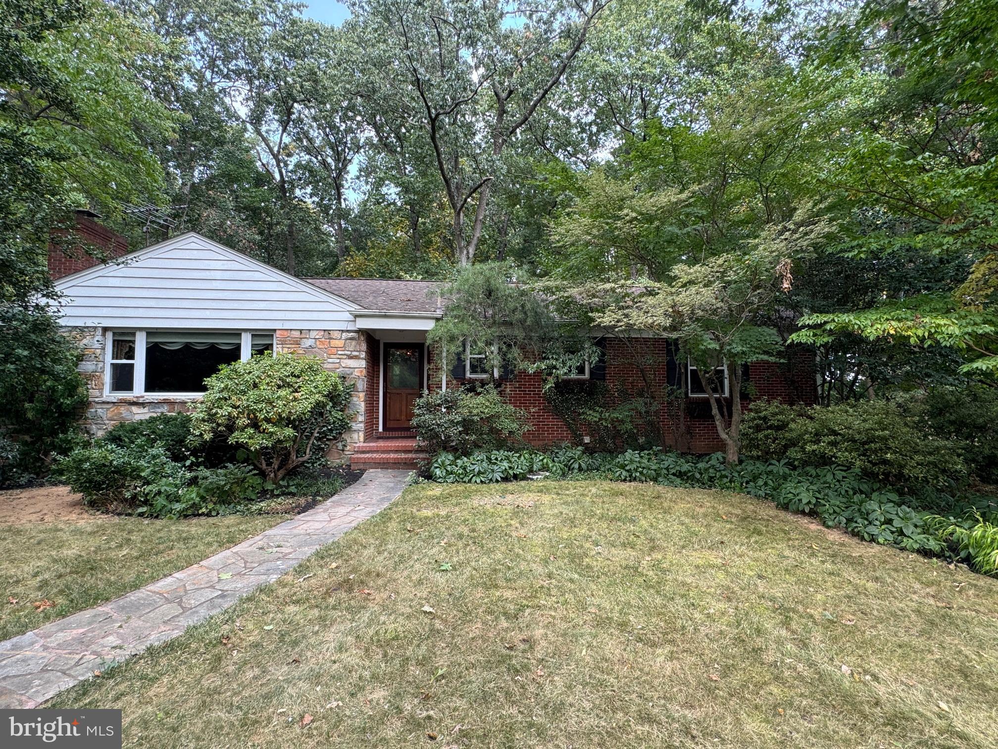 PRICE REDUCED to $20,000 below Appraisal!! This is a treasure waiting to be discovered; nestled in a serene and private setting. Welcome to this natural paradise surrounded by Horticulturist designed landscaping, brimming with specialty plants & trees. In the middle of all this beauty is a charming, solid brick, well cared for 3-bedroom ranch home with convenient one level living. You will be greeted by a stunning custom-made stained glass front door window. The spacious rooms are inviting and enhanced by crown molding and chair rails. The all-season porch will invite thoughts of entertaining, fun, and relaxing hours appreciating the sights and sounds of nature. The updated kitchen with Amish made cherry cabinets and granite countertops is beautiful. The old-fashioned built-in kitchen cabinet adds a yester-year detail. A door leads to a convenient pantry and a wooden staircase to the floored attic. The main level also has 3 generous sized bedrooms with oak flooring and one full & one-half ceramic tiled baths. The nearly new washer and dryer are conveniently located on this level. You won't want to miss the mostly finished lower level with a very large recreation room enhanced by luxury vinyl flooring and a whole wall of barn wood direct from a local farm. A private office/hobby room and full bath complete this area. Keep walking and you'll find a large storage area with built in shelving., a laundry tub and another very ample storage area with more shelving. And there's more......a large, beautiful cedar closet for all your off-season clothing. A stairway with Bilko doors leads to the outside. The house overlooks a conservation area and there's NO HOA! Hurry, this one is special!